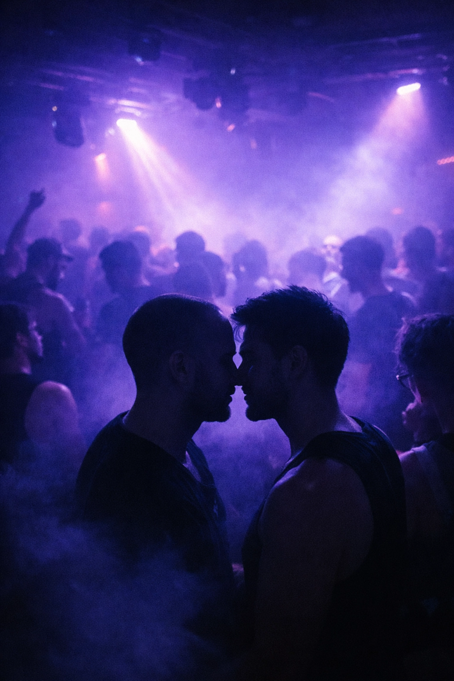 Two men at queer underground techno party with strobe lights and dancing crowd
