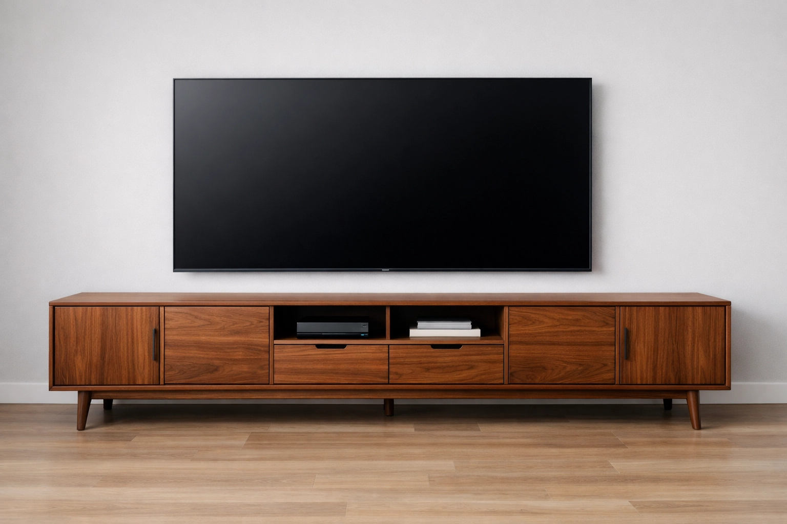 A 95-inch walnut TV console with tapered legs anchoring a large television in a modern home.