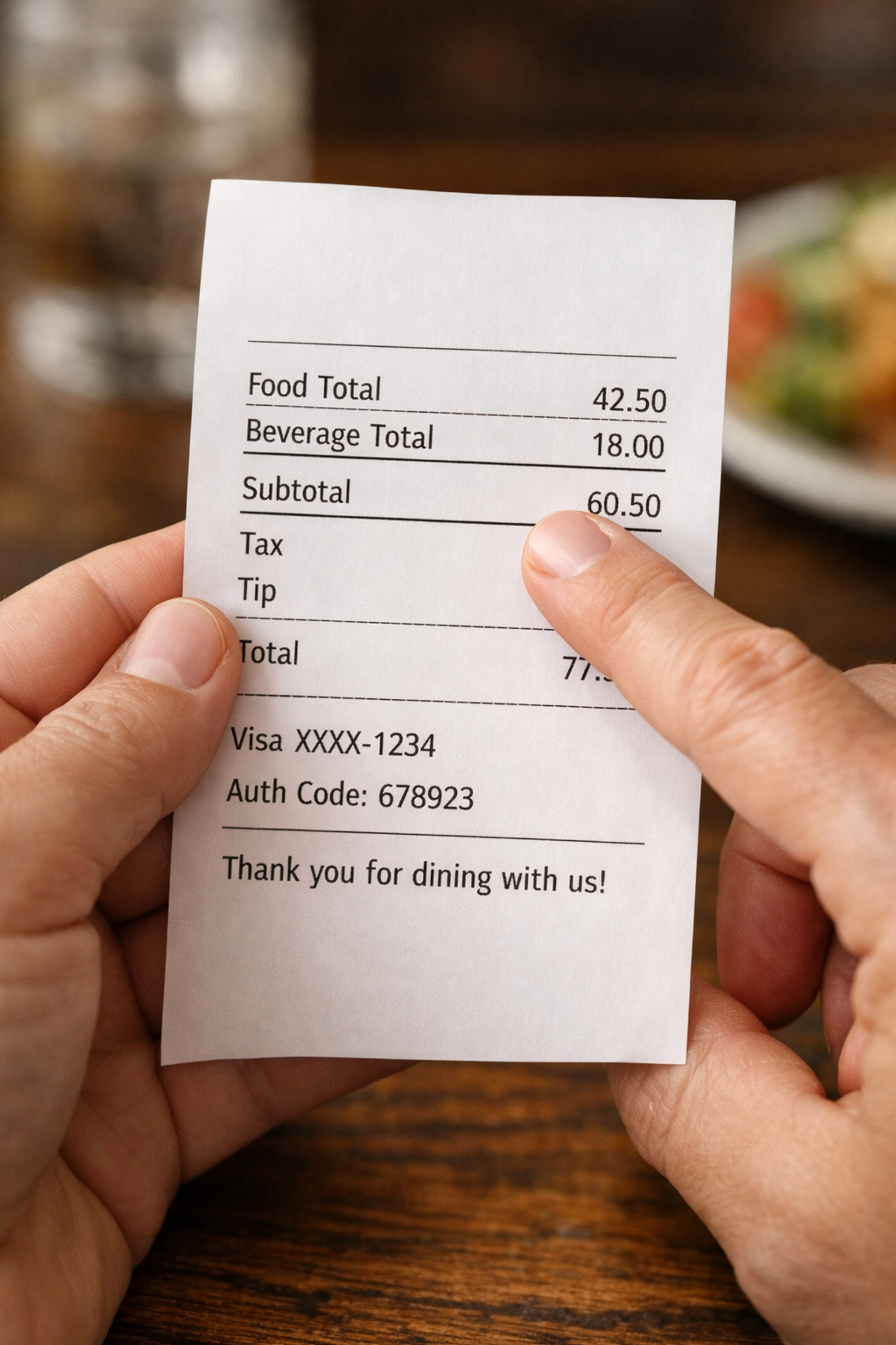 Hands reviewing itemized restaurant receipt showing separate food and entertainment charges