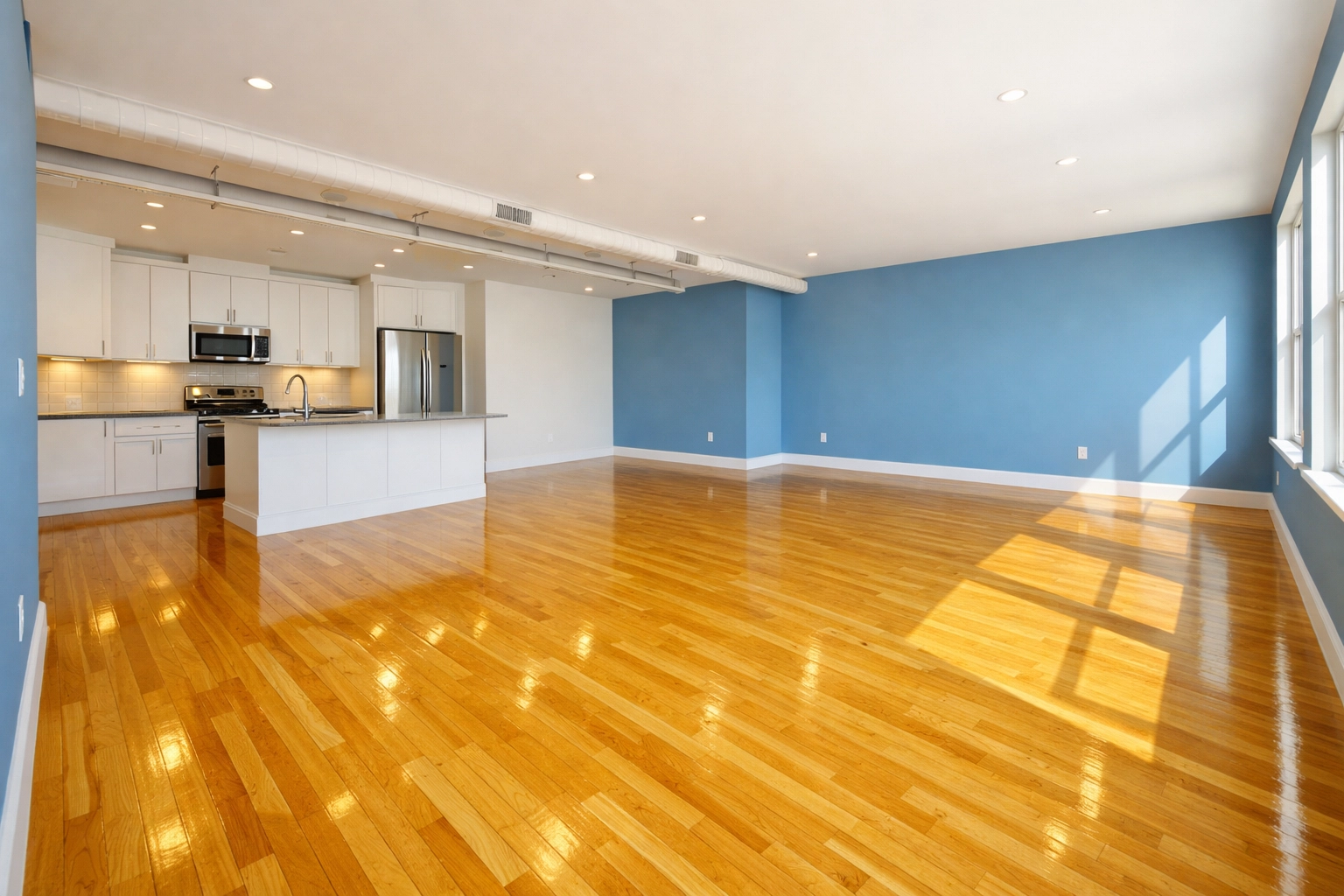Empty luxury loft with gleaming hardwood floors following move-out cleaning Central Square.