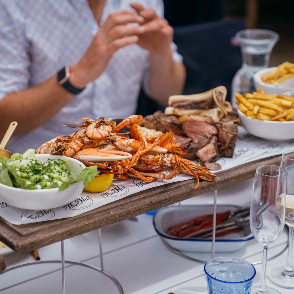 The Hut restaurant at Colwell Bay with private powerboat moored at jetty Isle of Wight