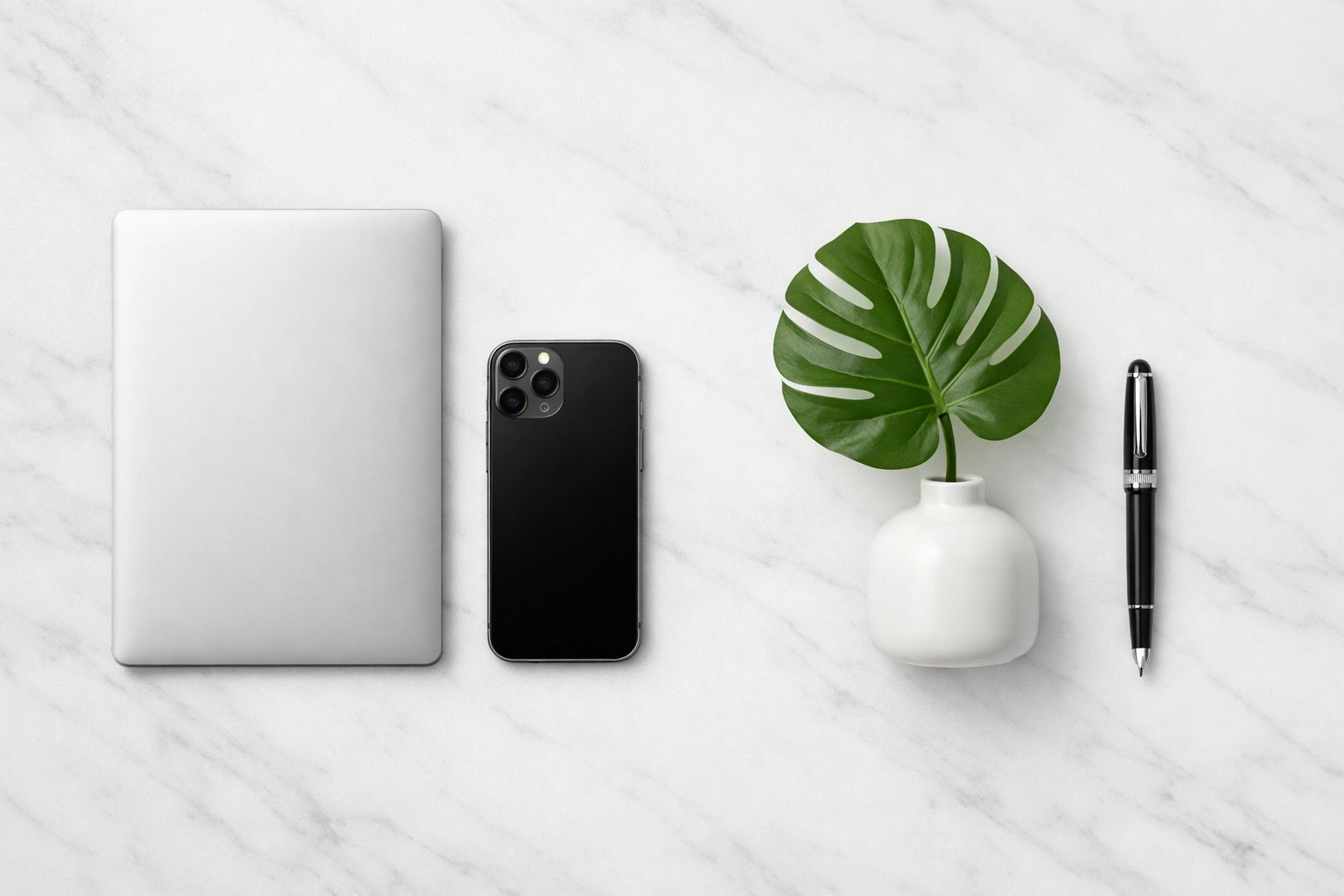 An organized desktop with a laptop and pen representing professional and precise notary services.