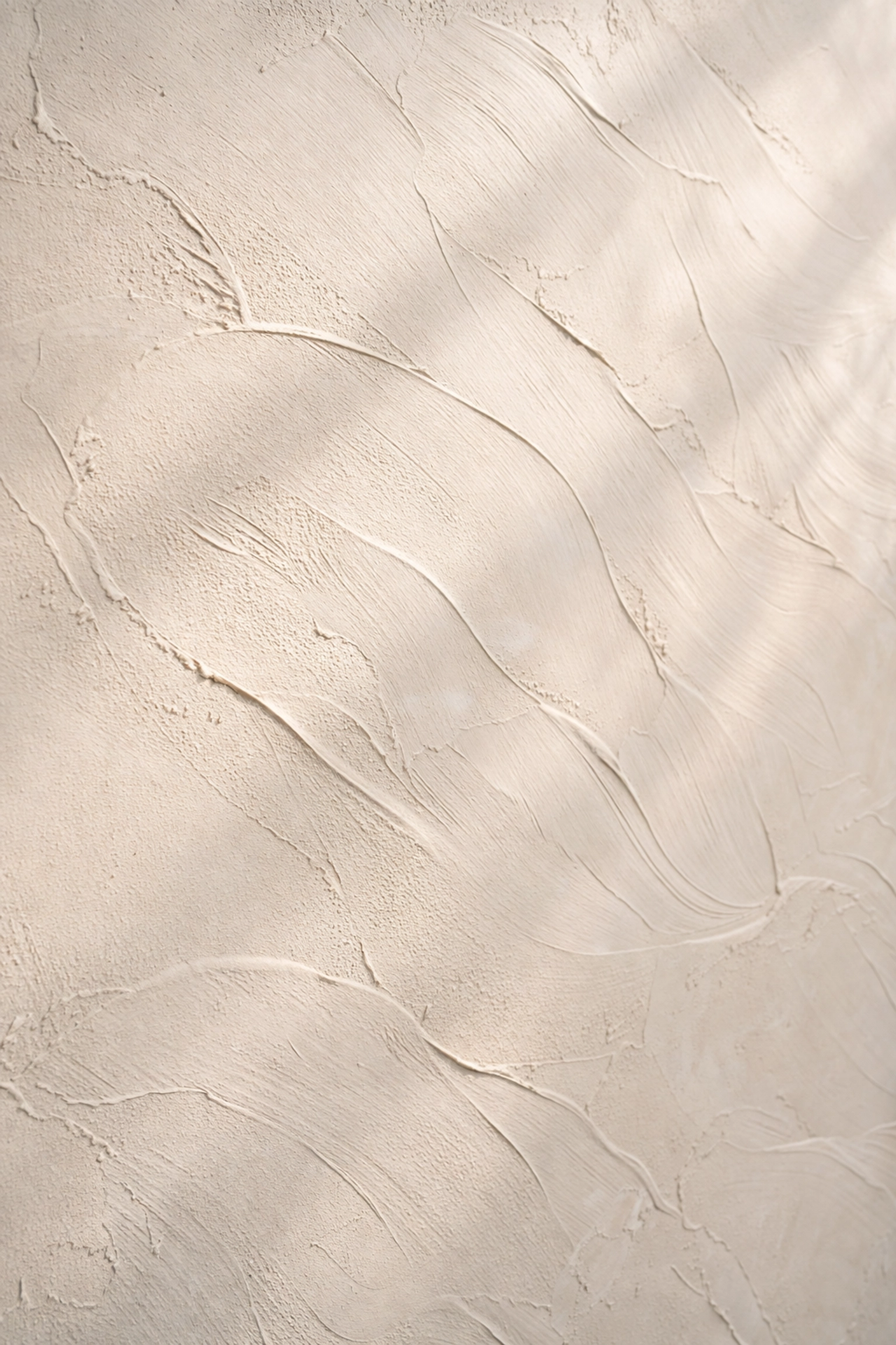 Detail of hand-troweled wall finish with elegant, textured surface in natural light for premium spaces