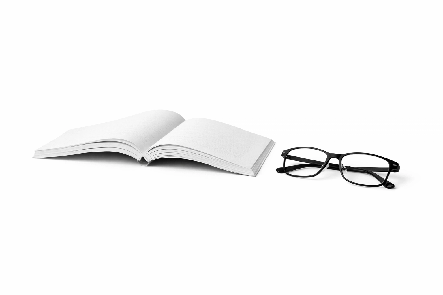 An open thin paperback book with reading glasses, illustrating the simplicity and focus of a short read.