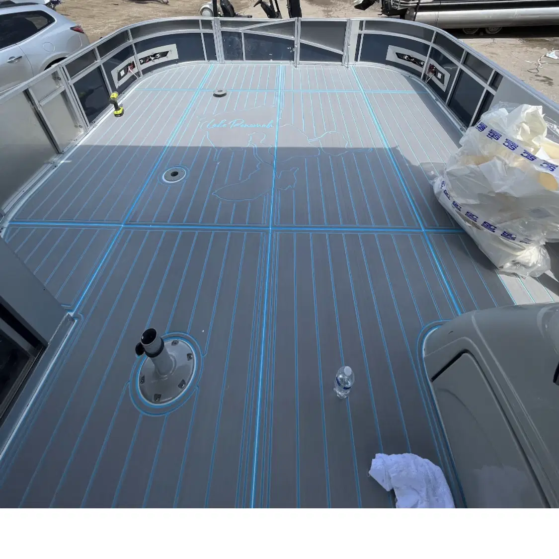 Custom synthetic decking featuring a detailed map inlay of a lake, providing a luxury personalized touch
