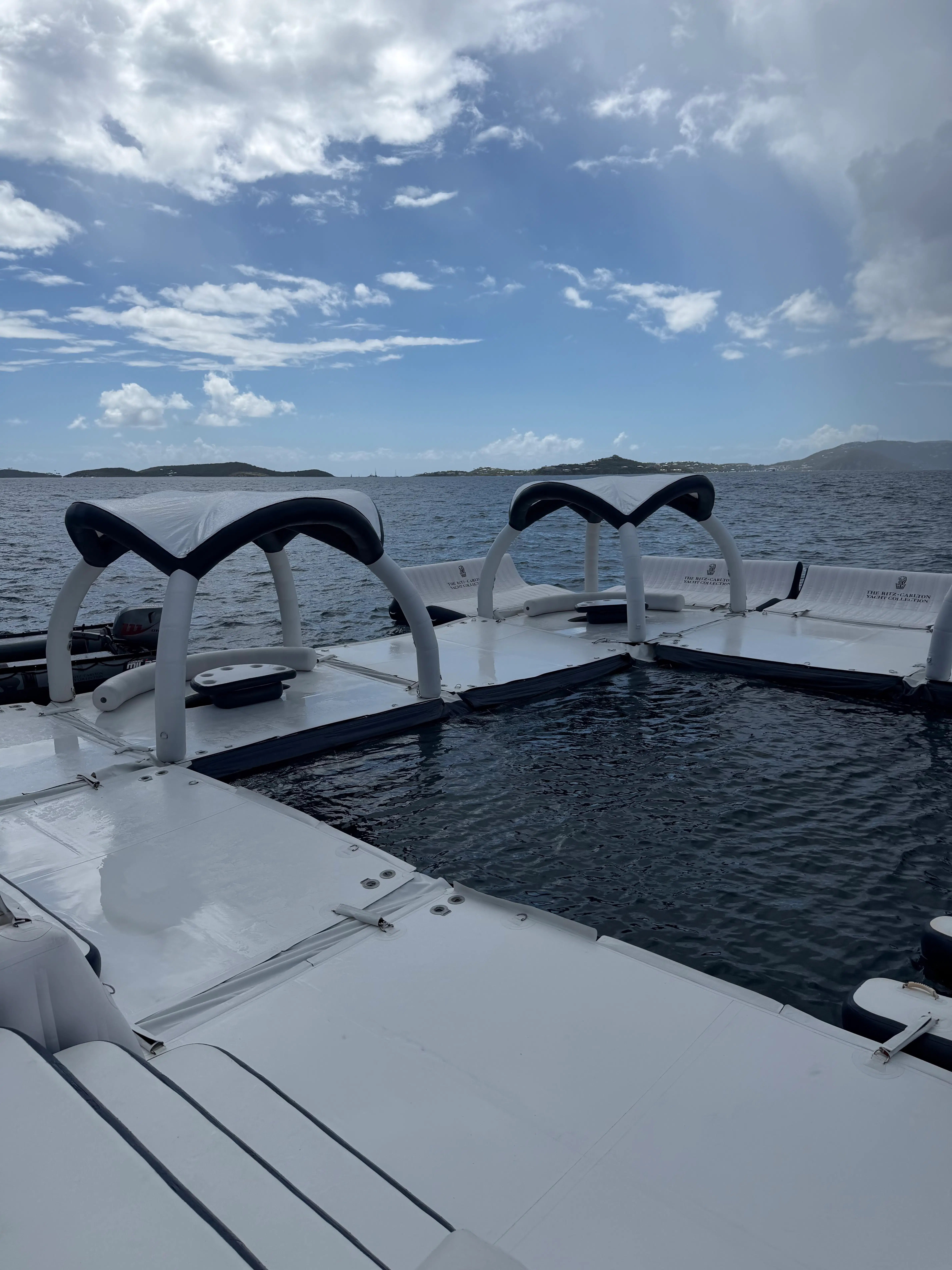 a boat with a body of water and a cloudy sky