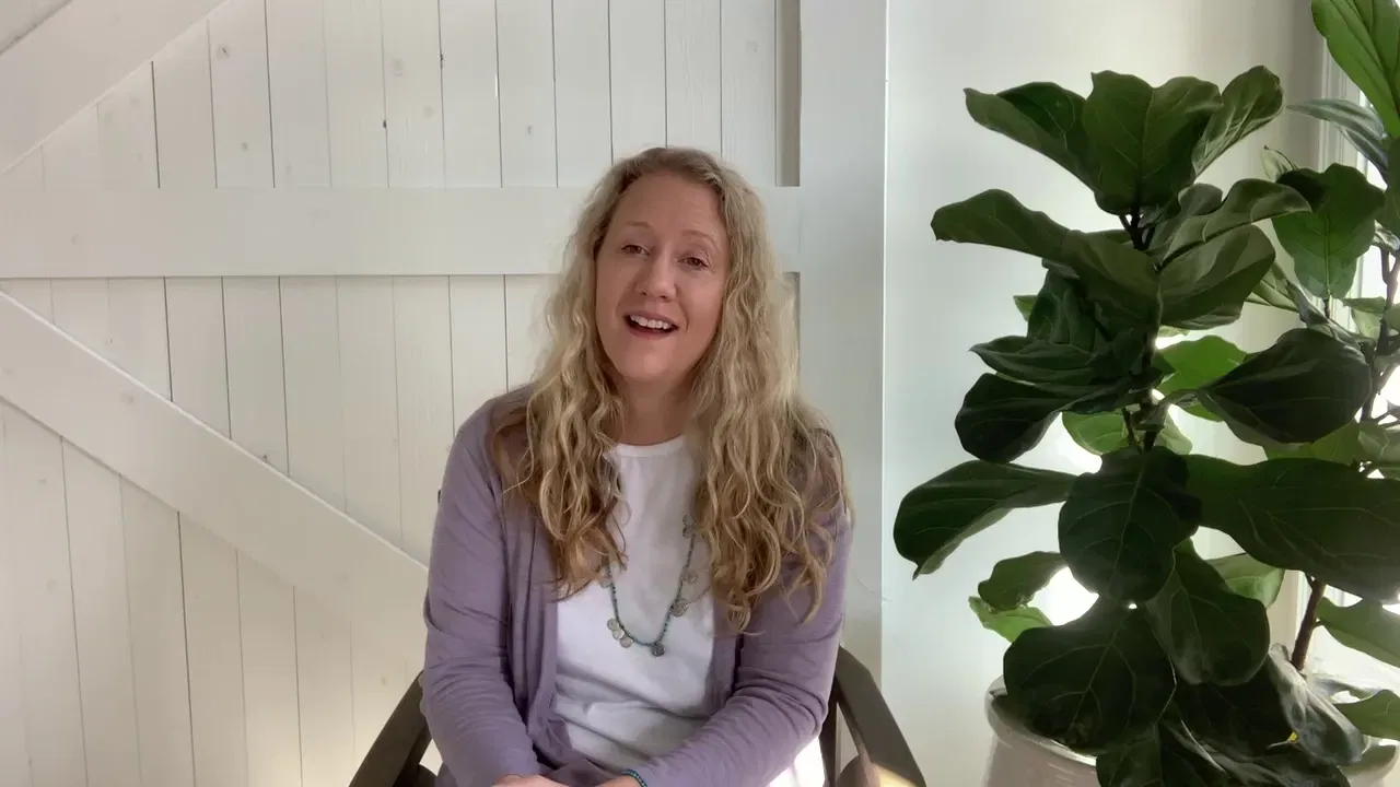 A smiling woman with long blonde hair sits in a bright, modern office space, conveying a welcoming approach to marketing partnerships