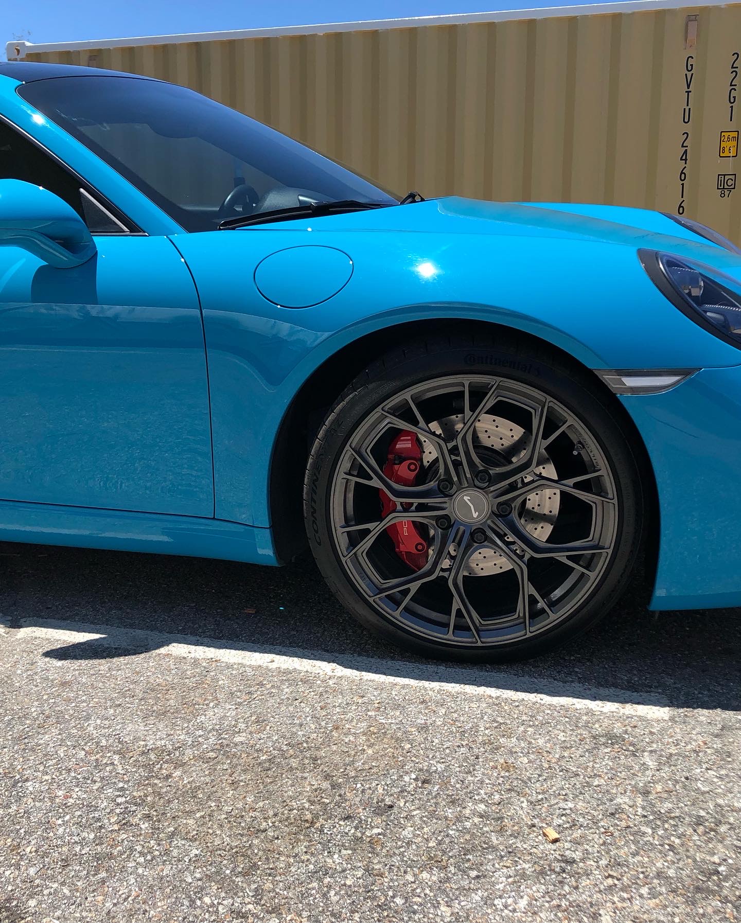 Bright blue sports car featuring custom powder coated wheels