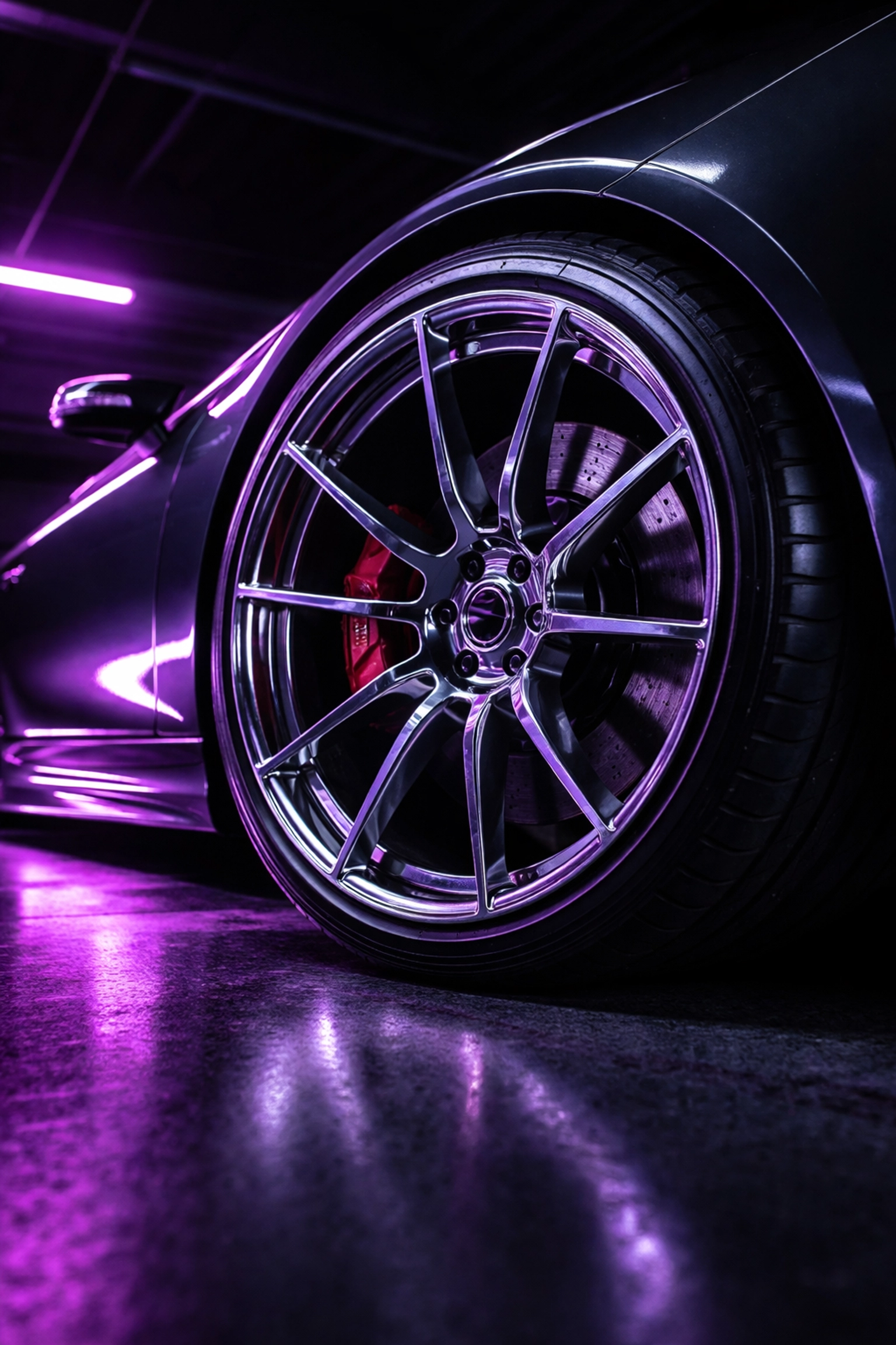 Freshly detailed alloy wheel and tire with a pristine, rich black shine, highlighting expert car care