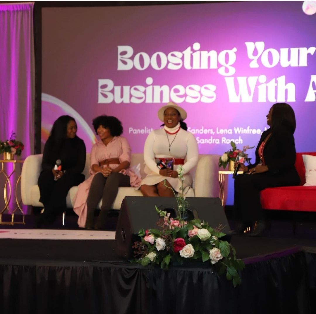 Four panelists engaged in a lively discussion during a business conference, showcasing professional event design.