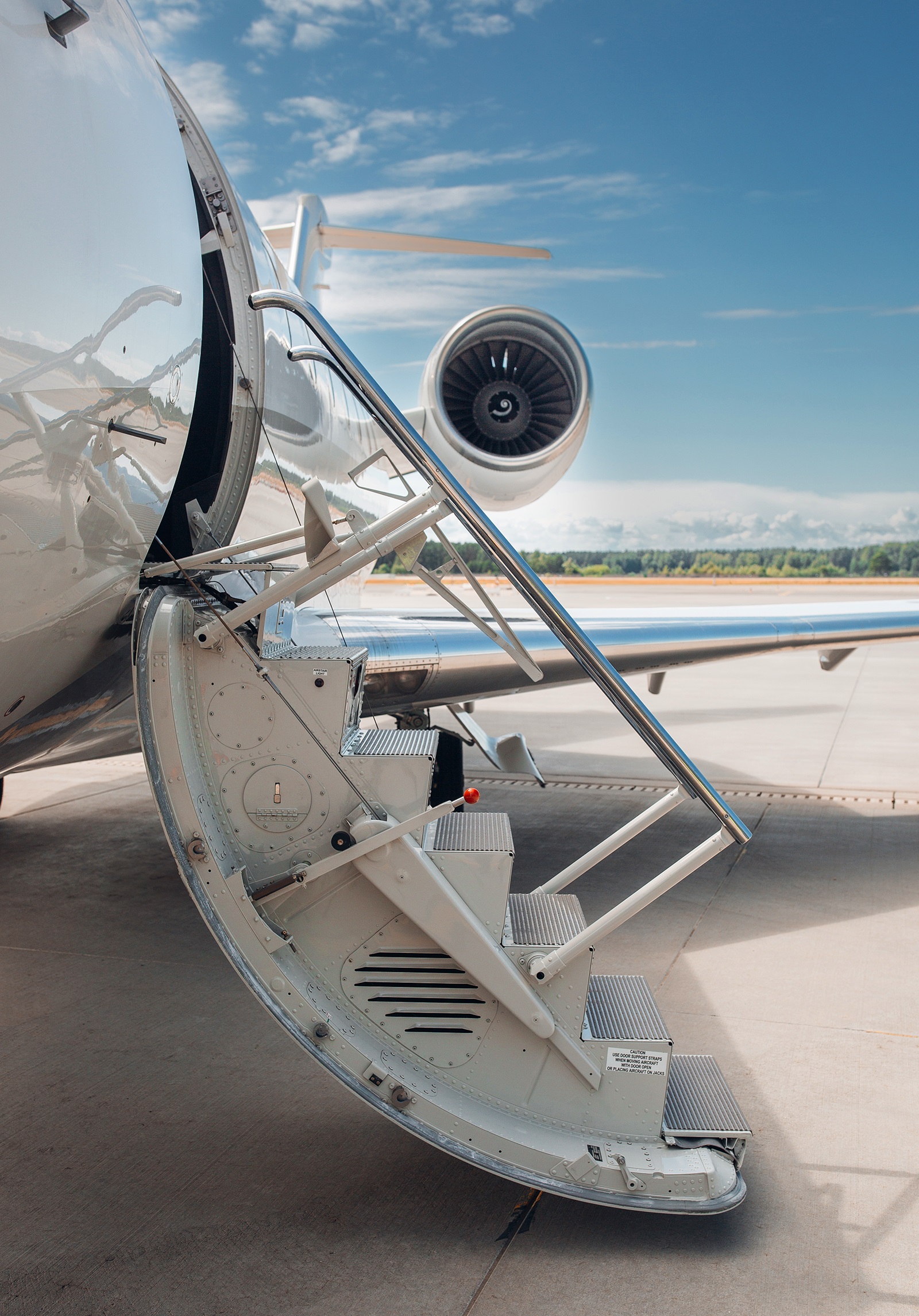 Close-up of a private jet on the tarmac at a European airport during peak summer season