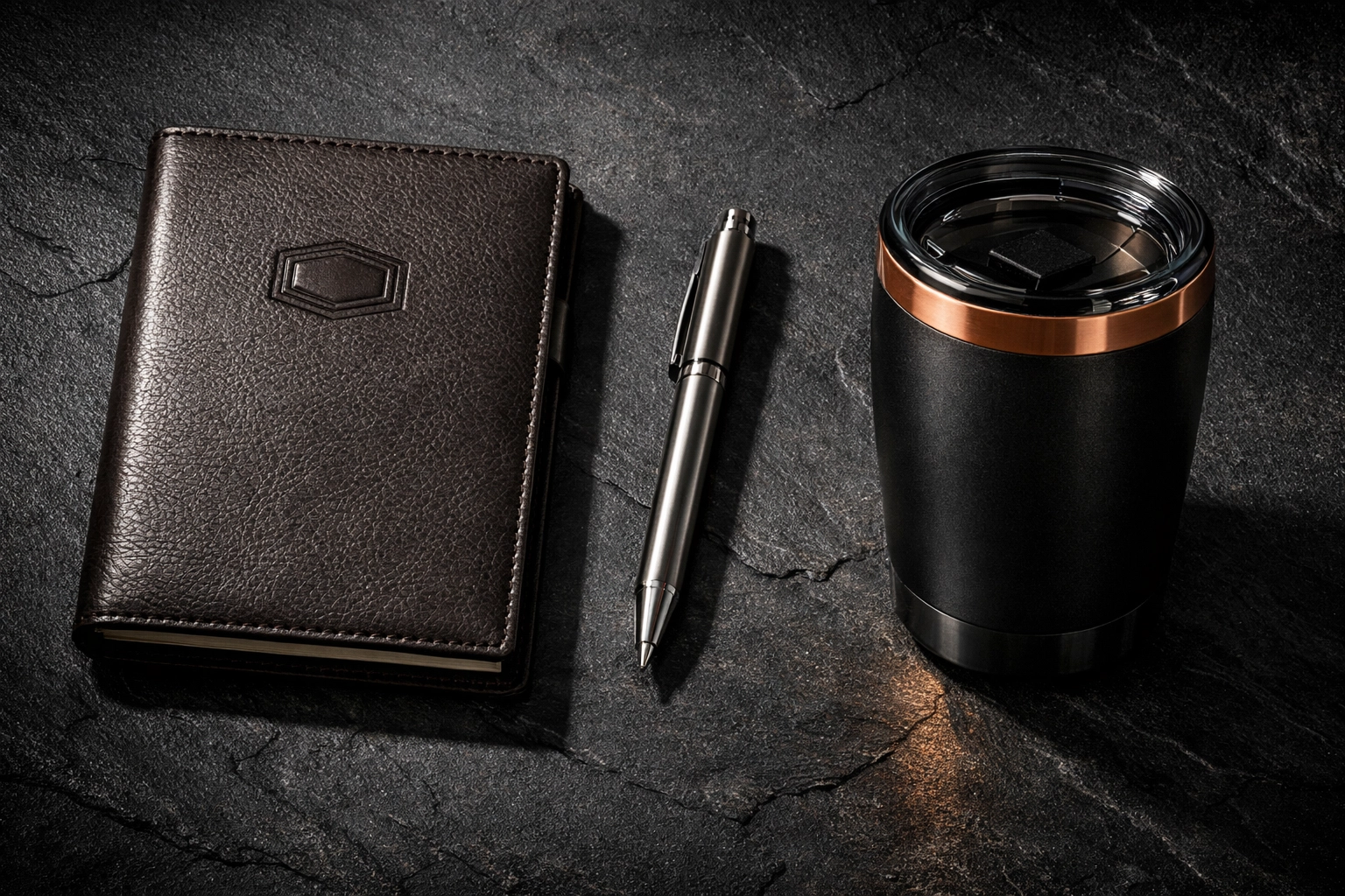Executive gift set including an embossed notebook and custom tumbler showing premium brand positioning.