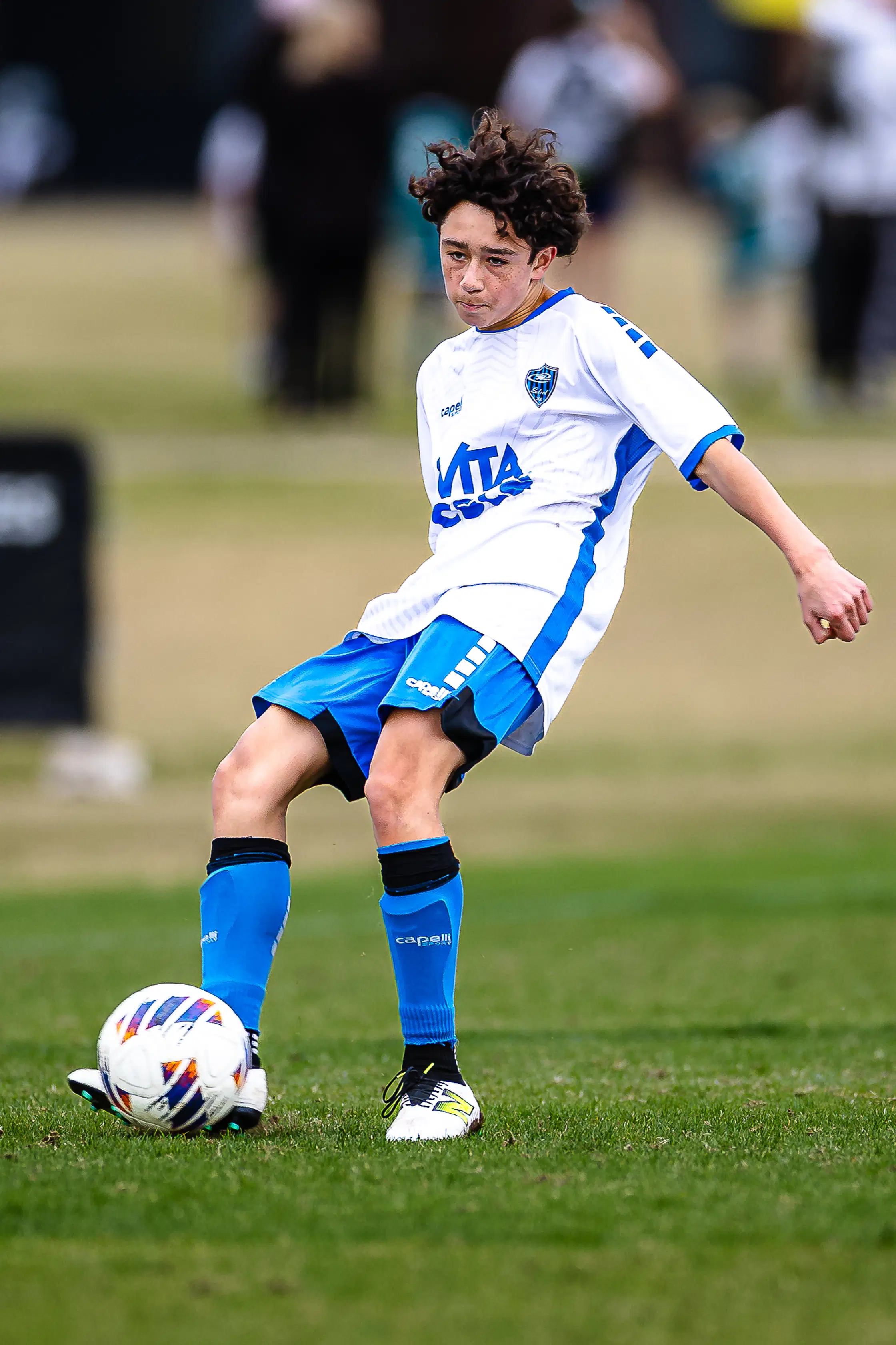 Technical precision: A high school soccer player maintains focus mid-pass, showing the athletic nuance captured by JTS Media.