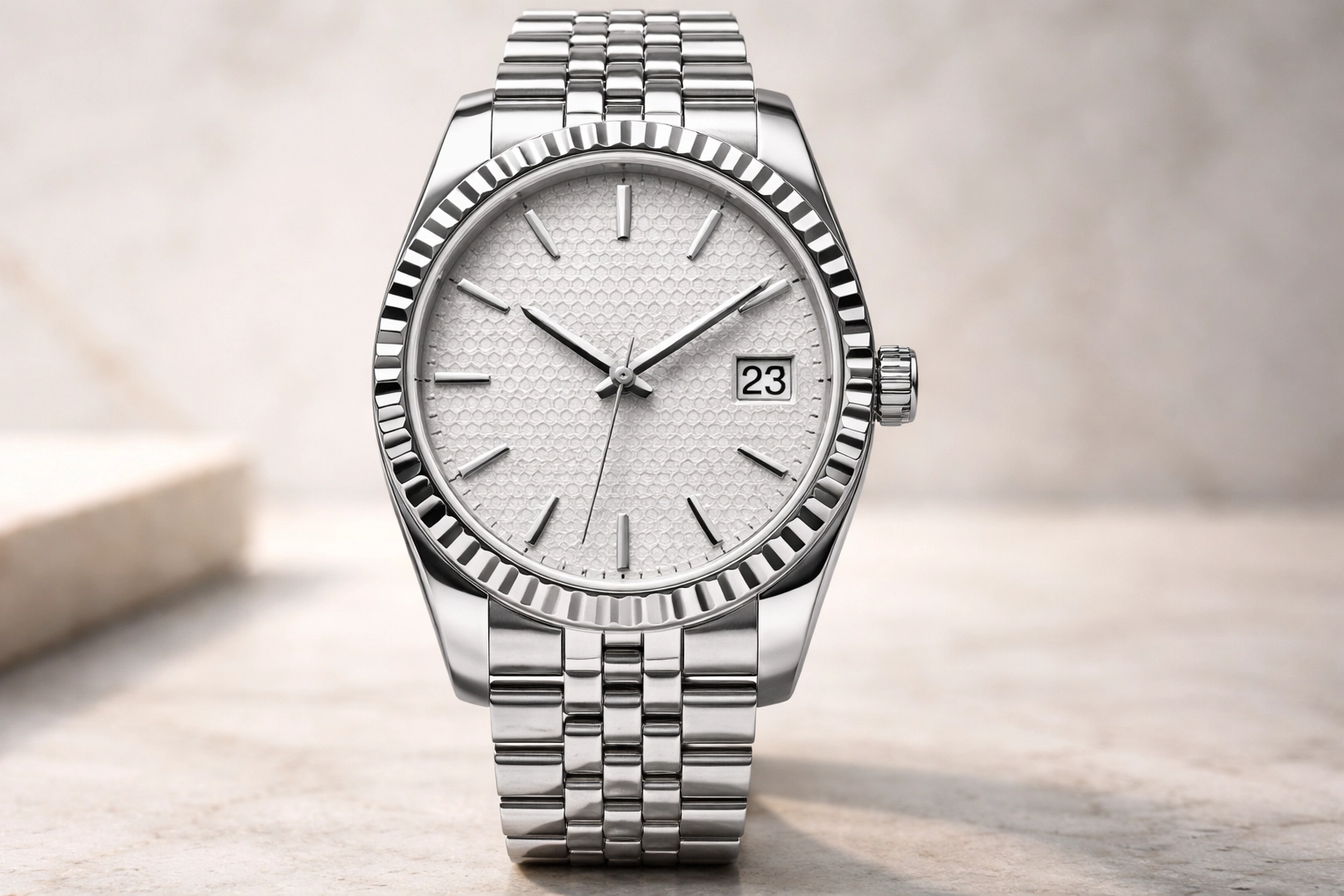 40mm White Rolesor luxury watch with fluted bezel, honeycomb motif dial, integrated Flat Jubilee bracelet, and date window at 3 o'clock, photographed upright in soft natural light with shallow depth of field