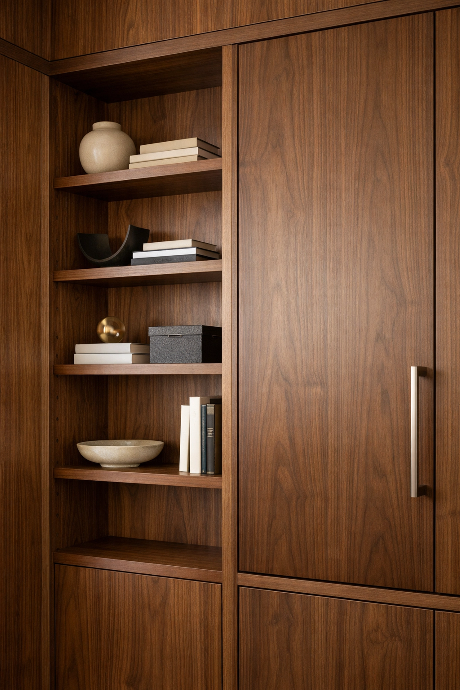 Floor-to-ceiling custom walnut office cabinets with adjustable shelving made in Minnesota.