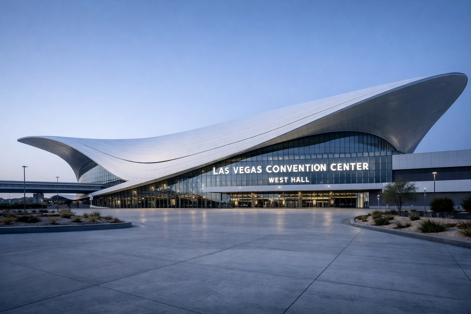 The modern exterior of the Las Vegas Convention Center West Hall at dawn.