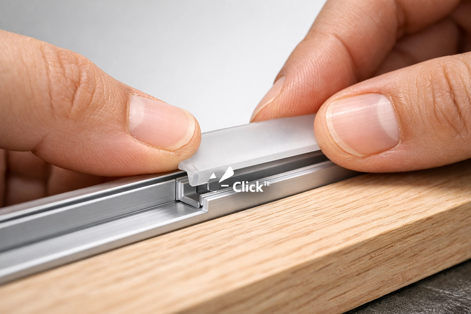 Installing a frosted LED diffuser channel lens into an aluminum extrusion for custom wood lighting.