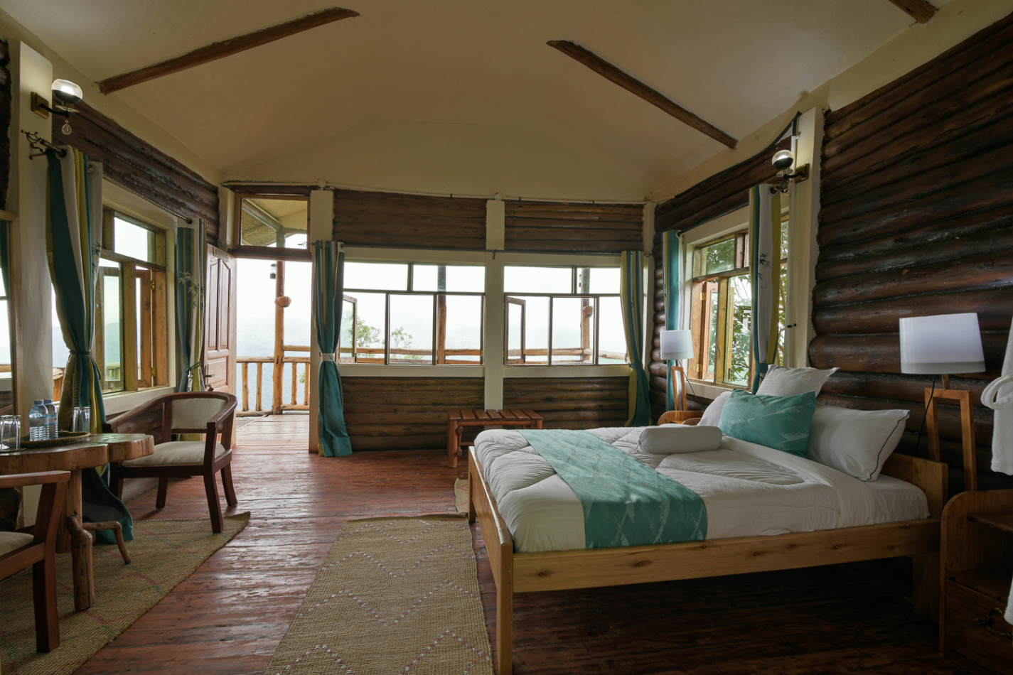 Eco-luxury guest room with rustic log cabin design and forest views in Bwindi, Nkuringo