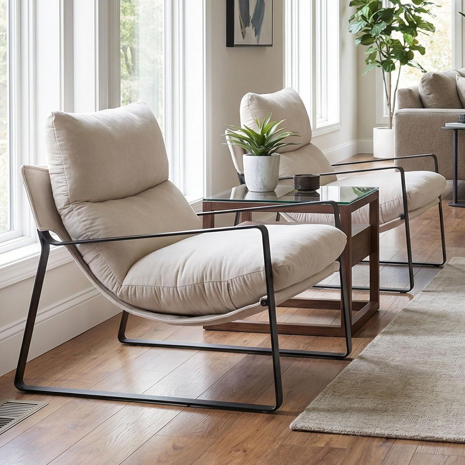 Modern sitting area featuring two cream upholstered lounge chairs, highlighting a no-demo luxury interior design transformation.