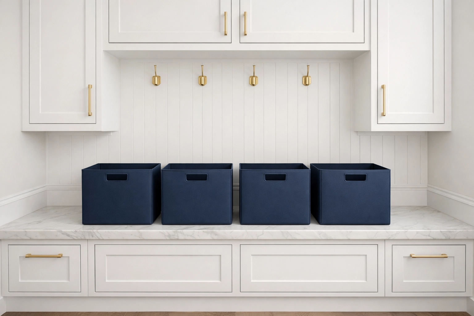 Four navy storage bins on a marble bench representing the Four-Basket Method for home organization.