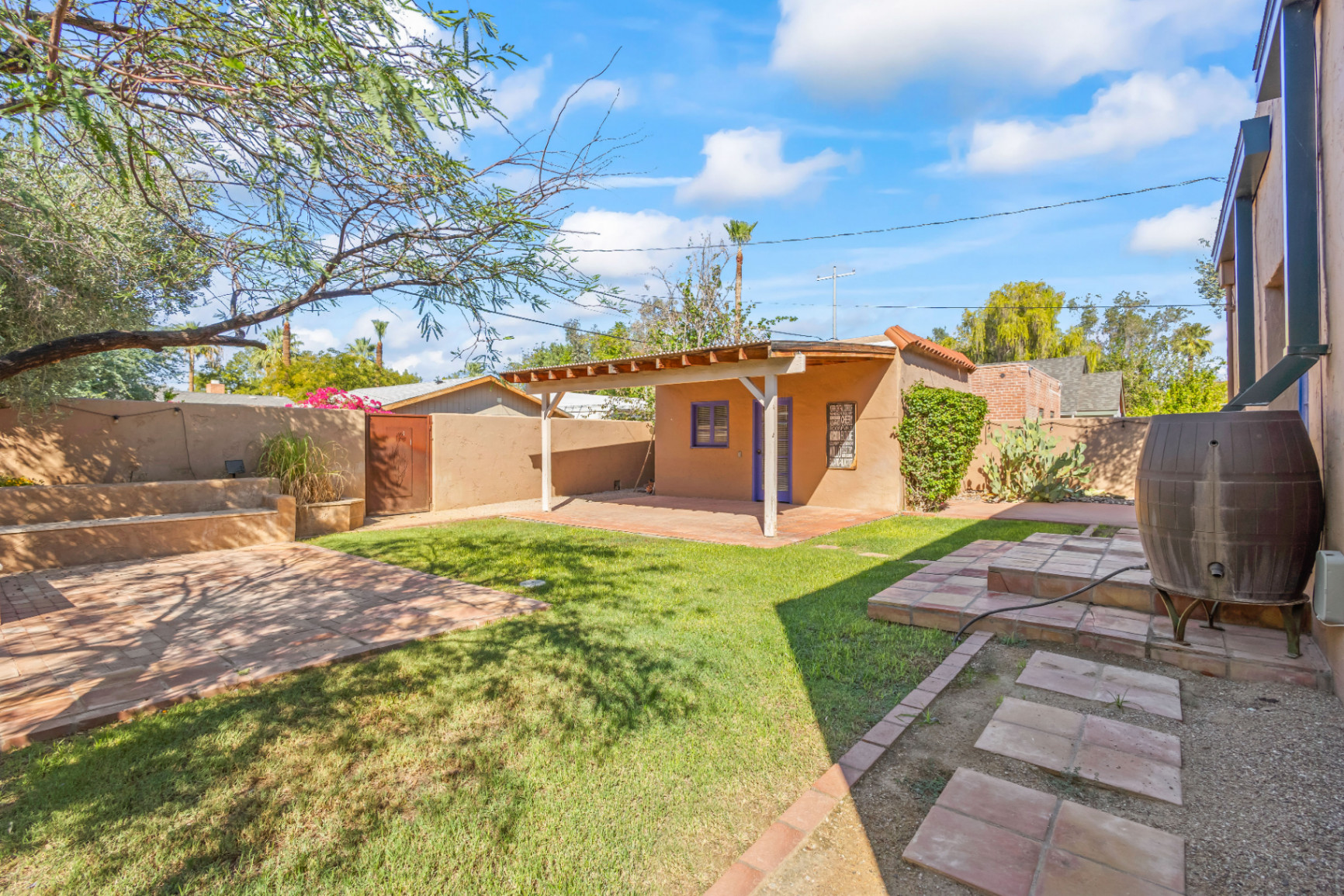 Contemporary waterfront home A modern home featuring mixed wood, stone, and metal accents, large windows, and lush landscaping.