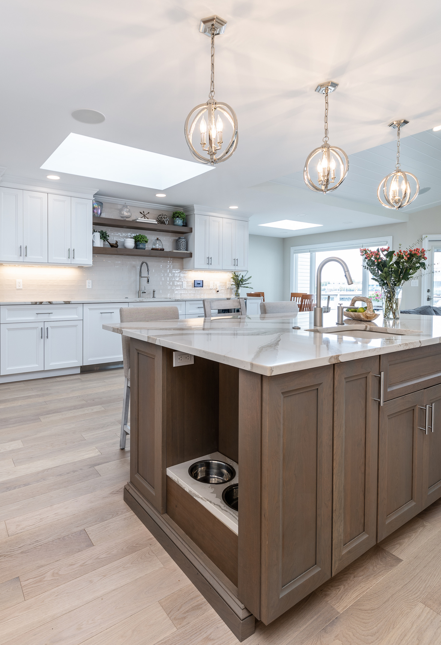 Custom kitchen on Long Island featuring integrated pet feeding station, custom cabinetry, and tailored millwork details