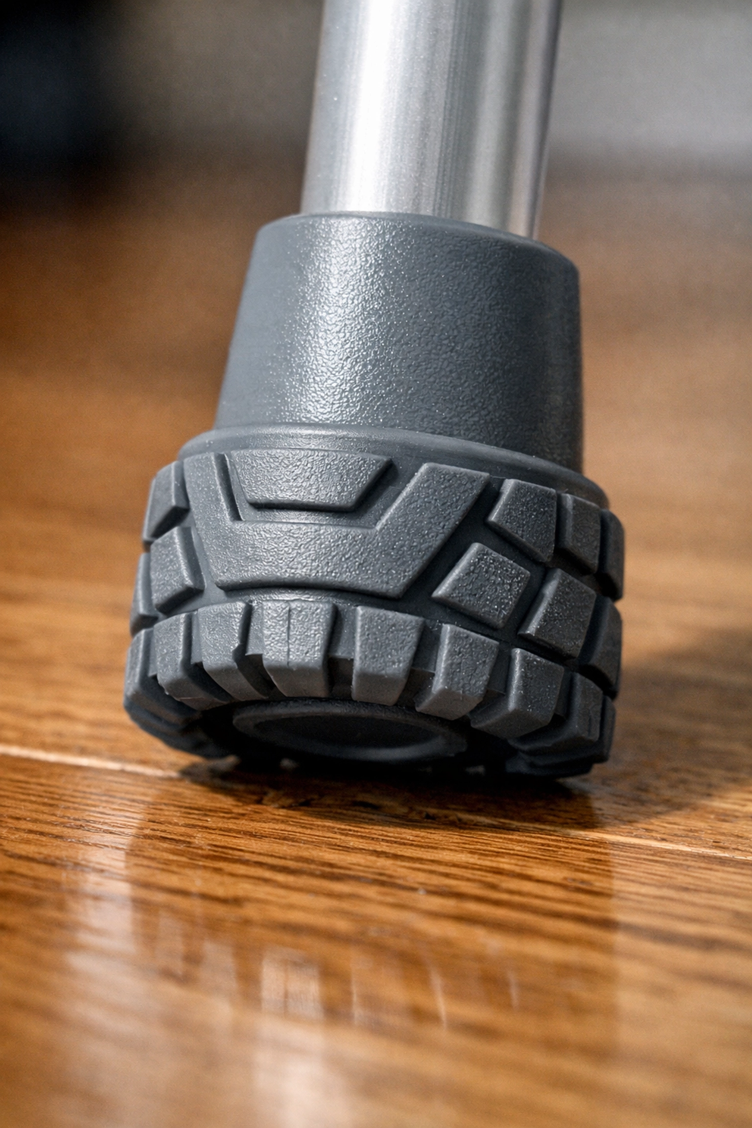 Close-up of a durable rubber walker tip with traction treads for better grip and safety on indoor floors.