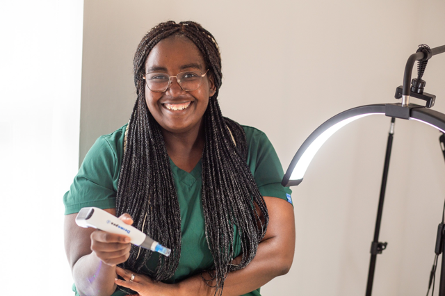 A practitioner at Ada Aesthetics with microneedling device