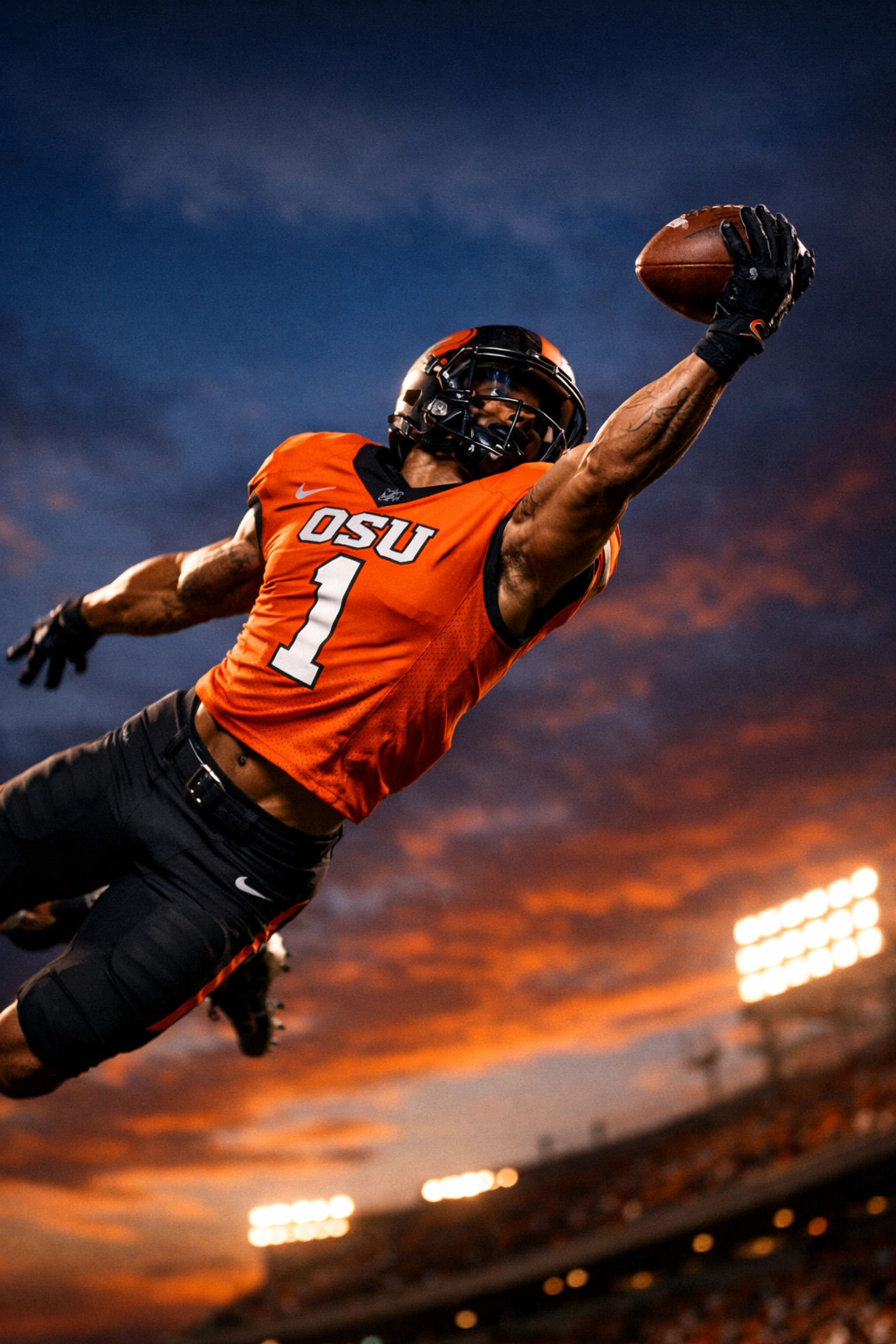 OSU wide receiver making spectacular catch in Oklahoma State orange and black uniform