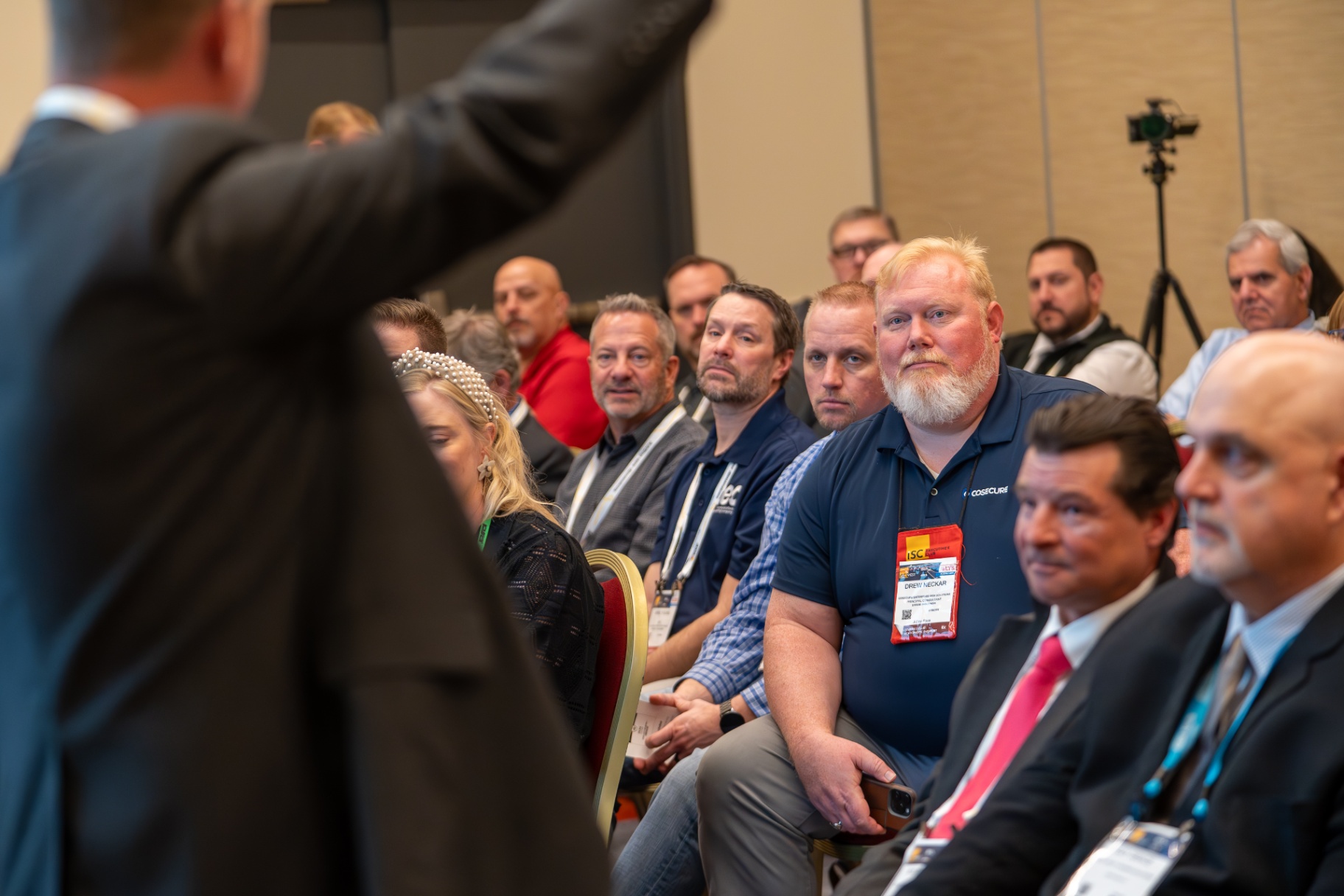 Corporate professionals seated at a business conference