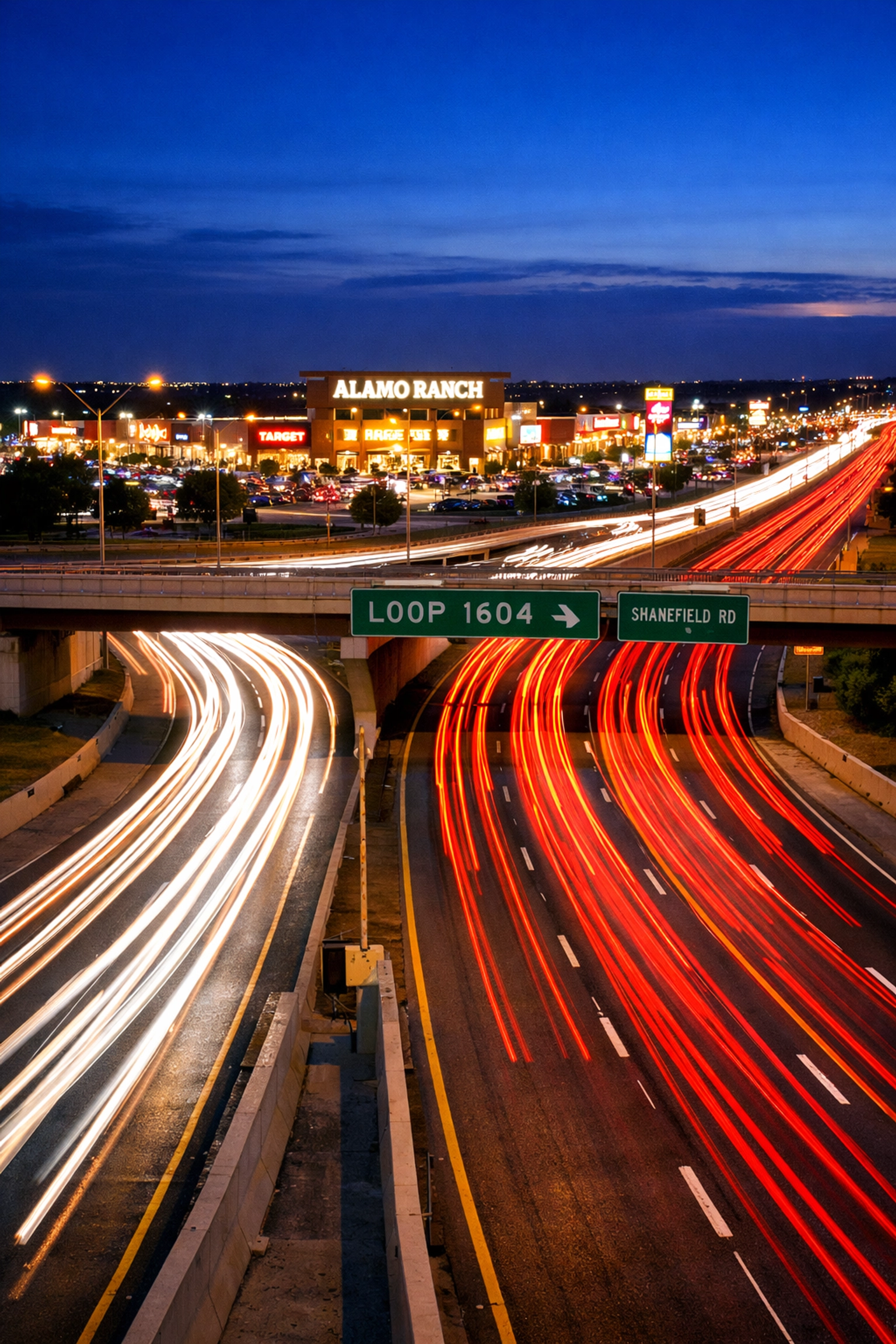 Night traffic on Loop 1604 showing the rapid infrastructure growth near Alamo Ranch shopping.