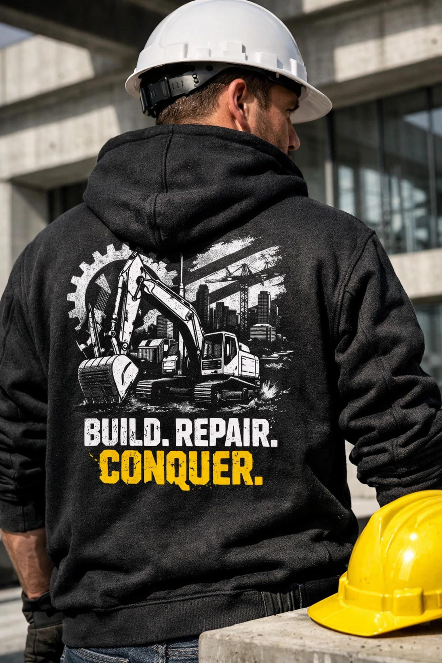Construction worker in a heavy-duty black hoodie featuring a high-contrast industrial back print on a job site.