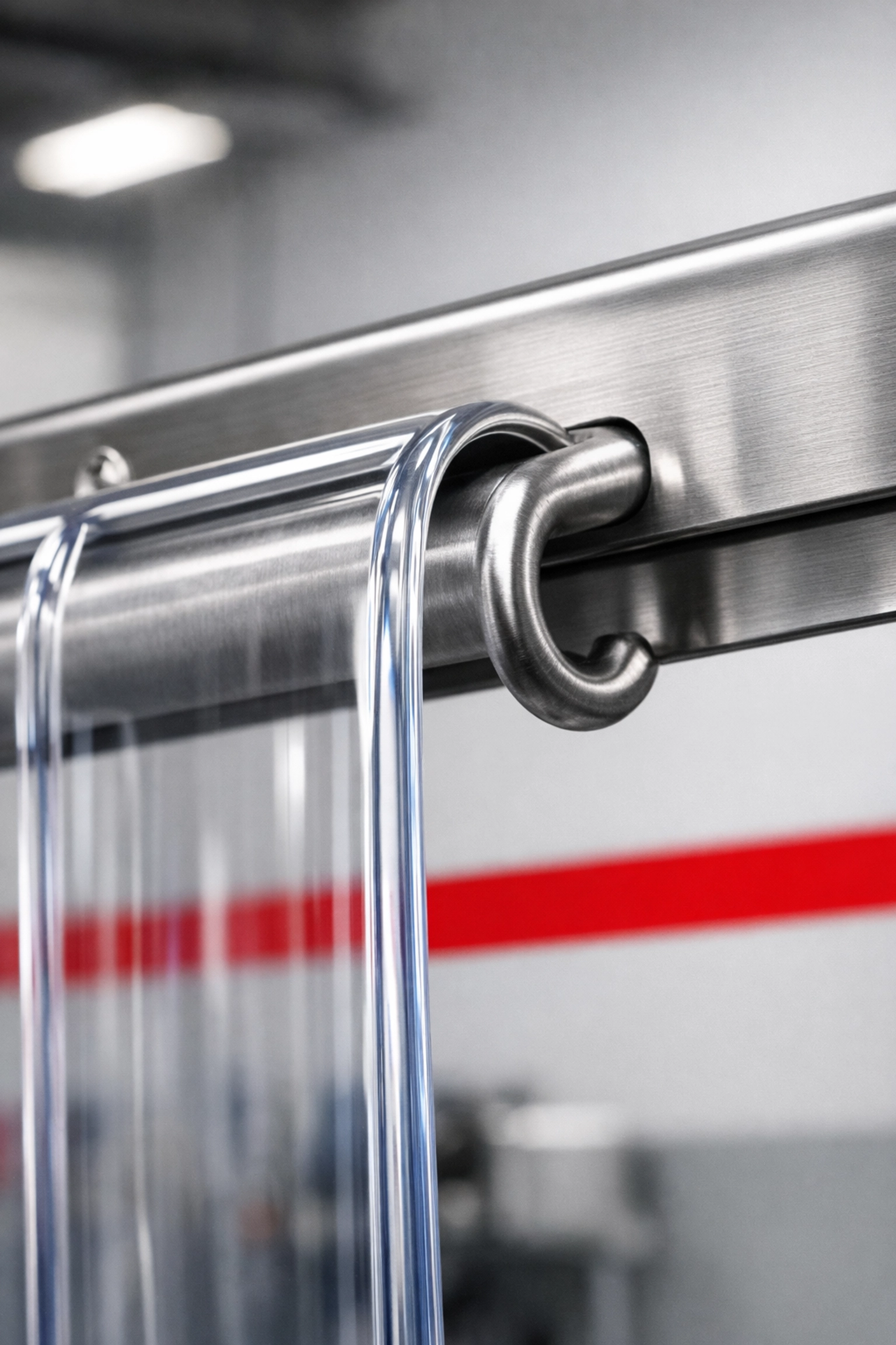 Stainless steel hook-on hanging system for transparent PVC strips with rounded safety edges.