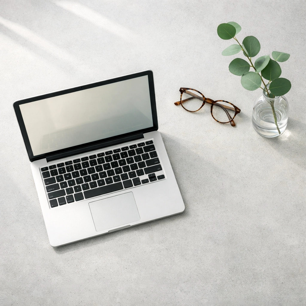 Minimalist hotel manager workspace on a concrete desk representing organized data-driven operations.