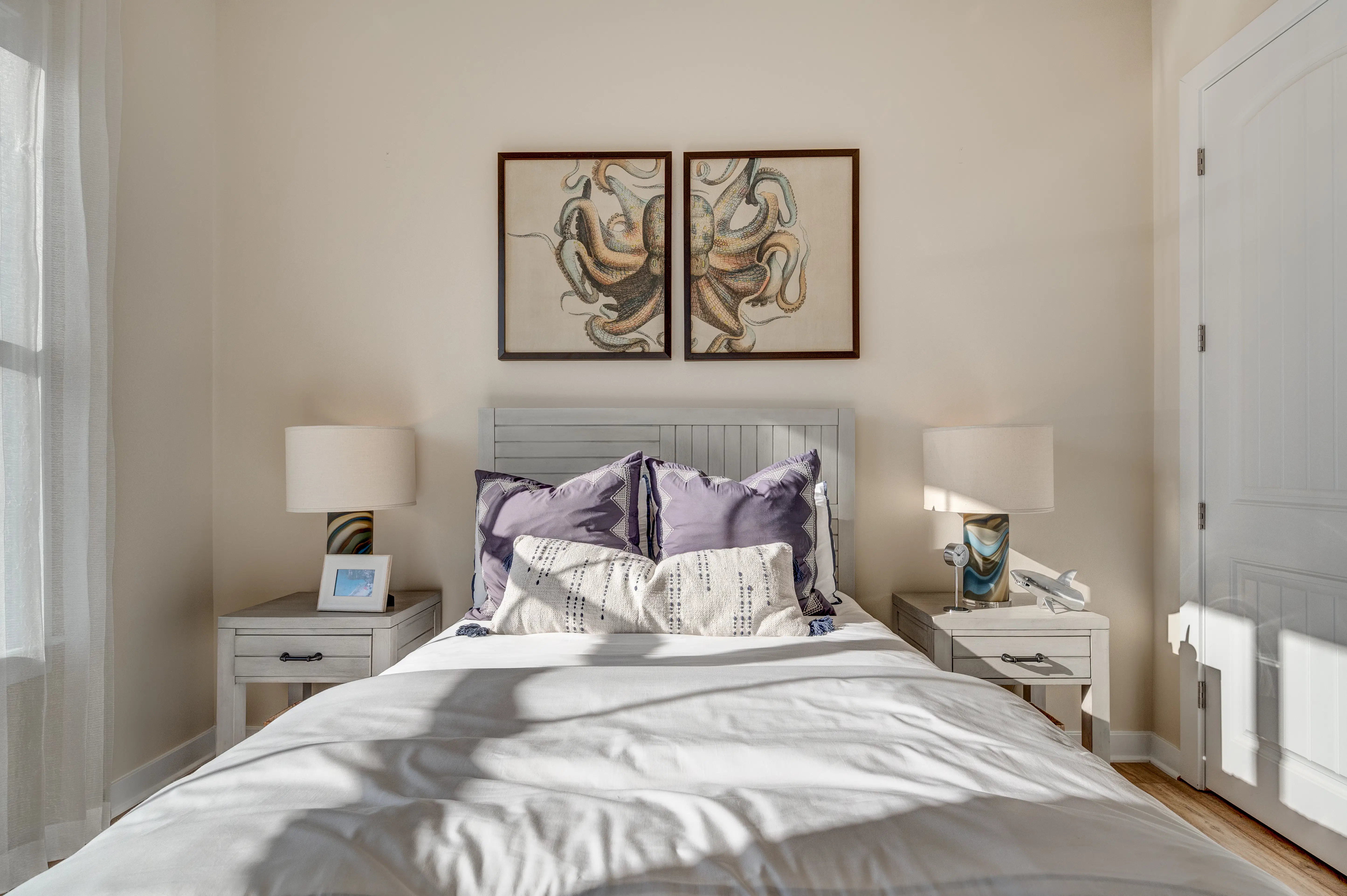 Bright and inviting coastal bedroom featuring octopus artwork