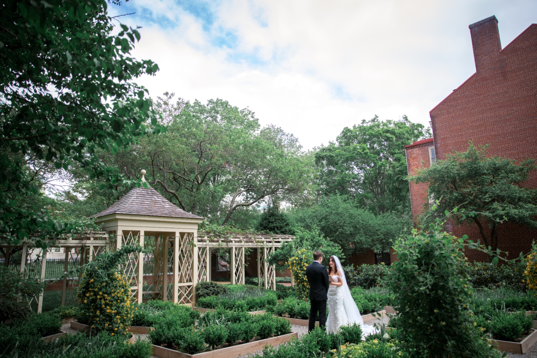 Leighanna and Brian share an intimate garden portrait surrounded by lush greenery