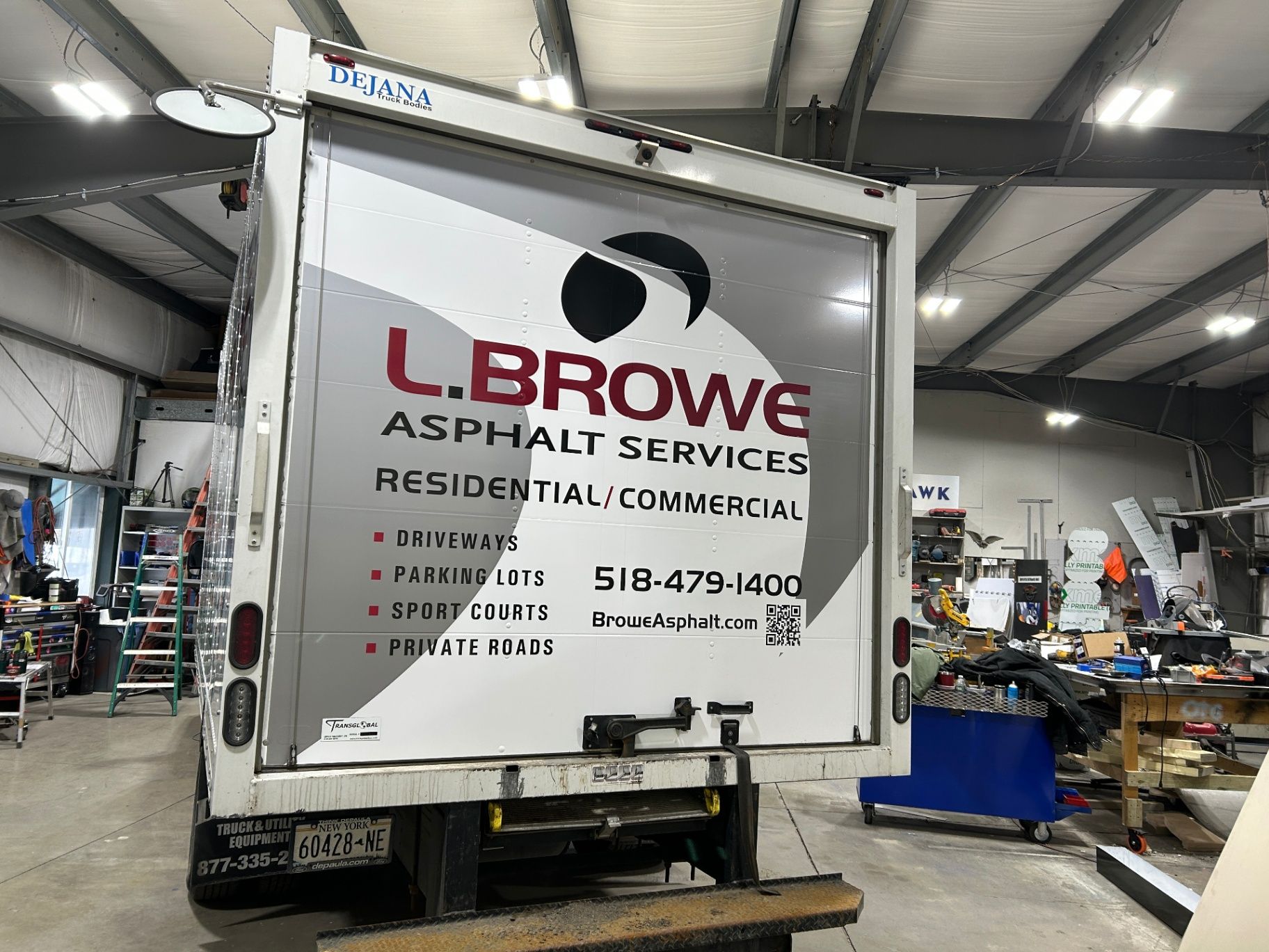 Rear view of a service truck featuring contact info and a QR code for easy lead capture.