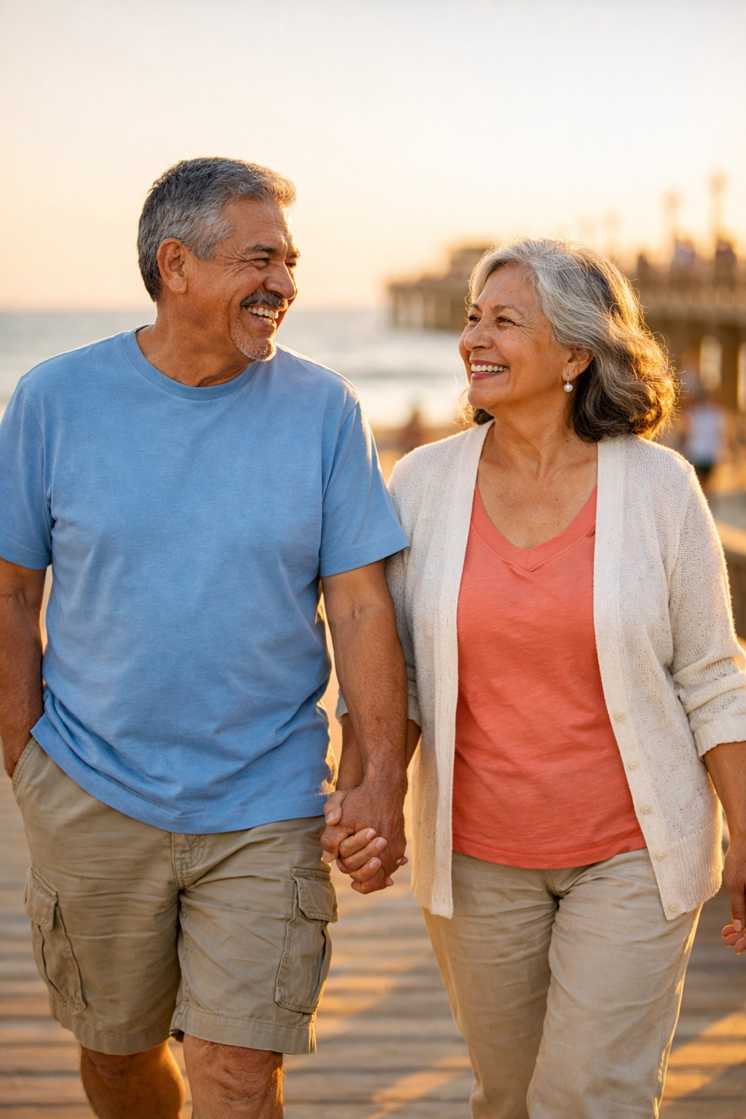 Happy retired couple enjoying beach walk during their retirement years