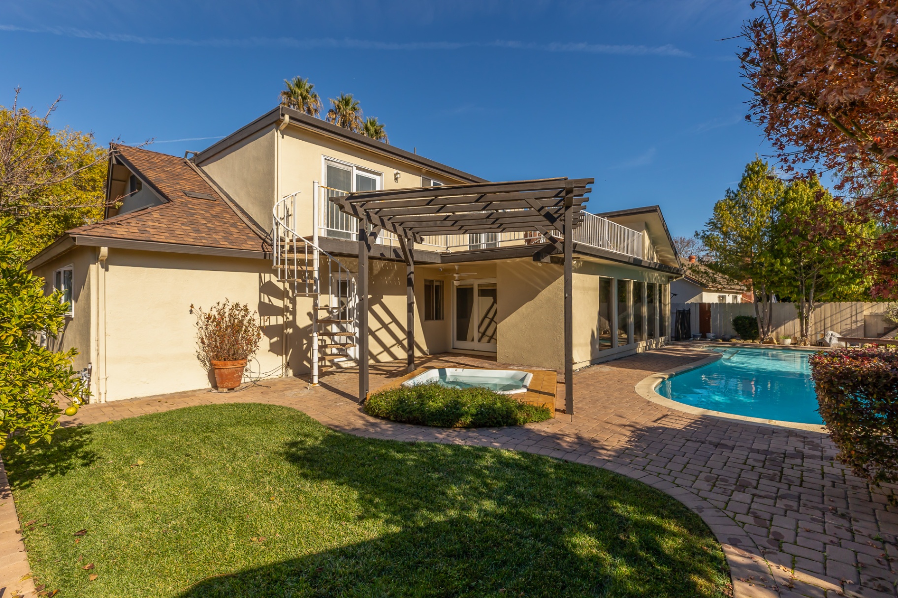 Outdoor entertaining area with pool and hot tub