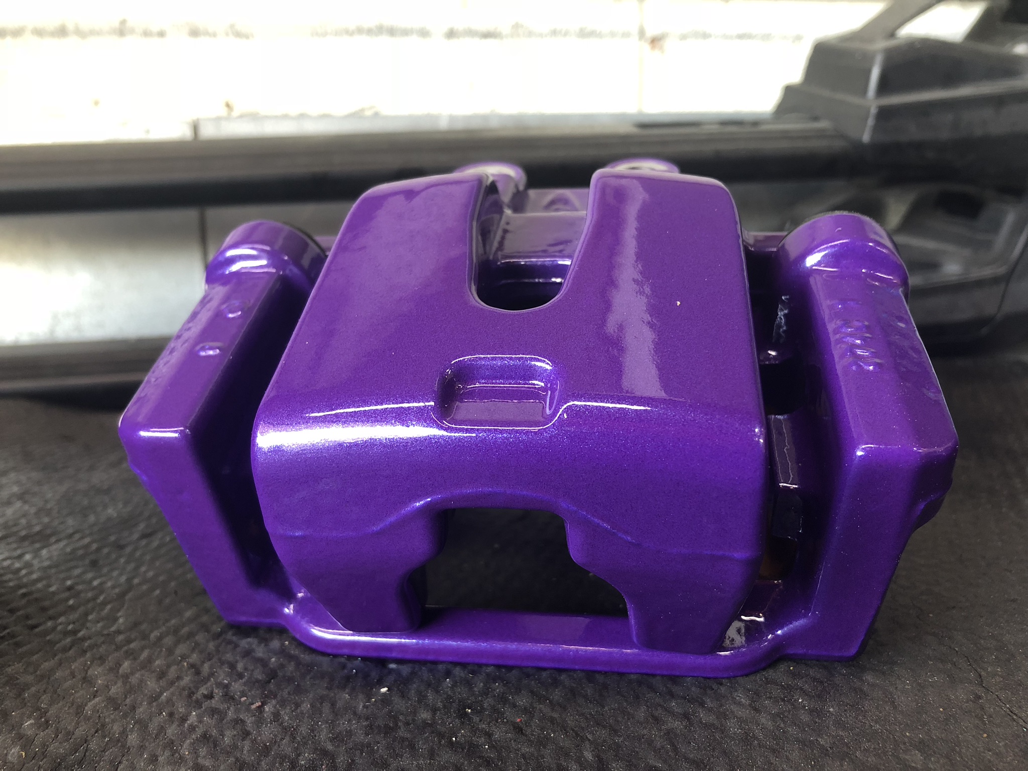 Plum Crazy Purple powder-coated brake caliper showcasing Mopar factory color matching.