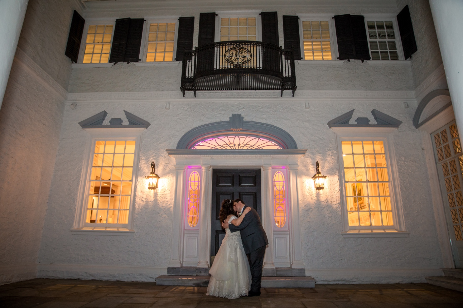 Bride and groom share a kiss under glowing market lights in a snowy night scene