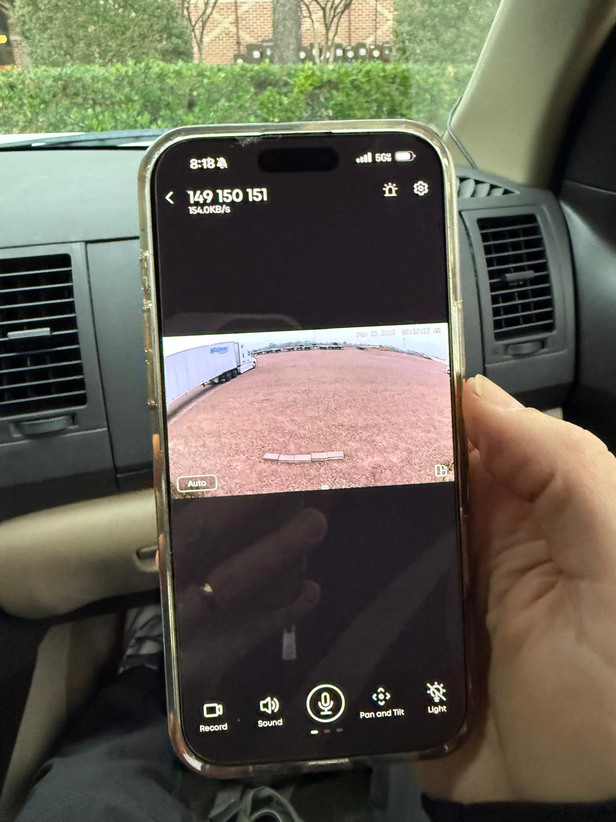 Customer checking SmartSpot™ on their phone while parked, getting real-time eyes on their rig for peace of mind.