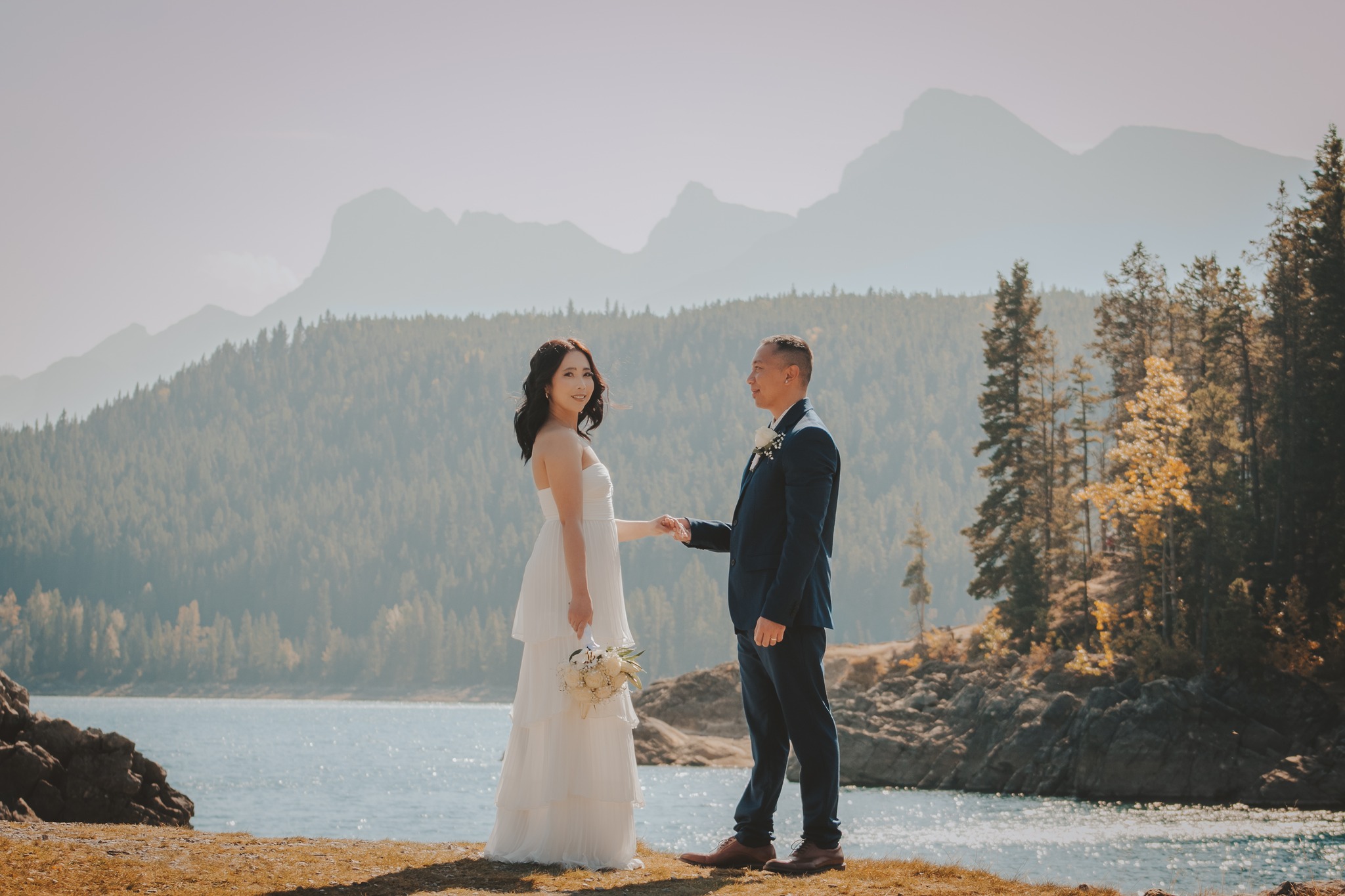Couple overlooking Moraine Lake on a moody day for their adventurous Banff mountain elopement wedding.