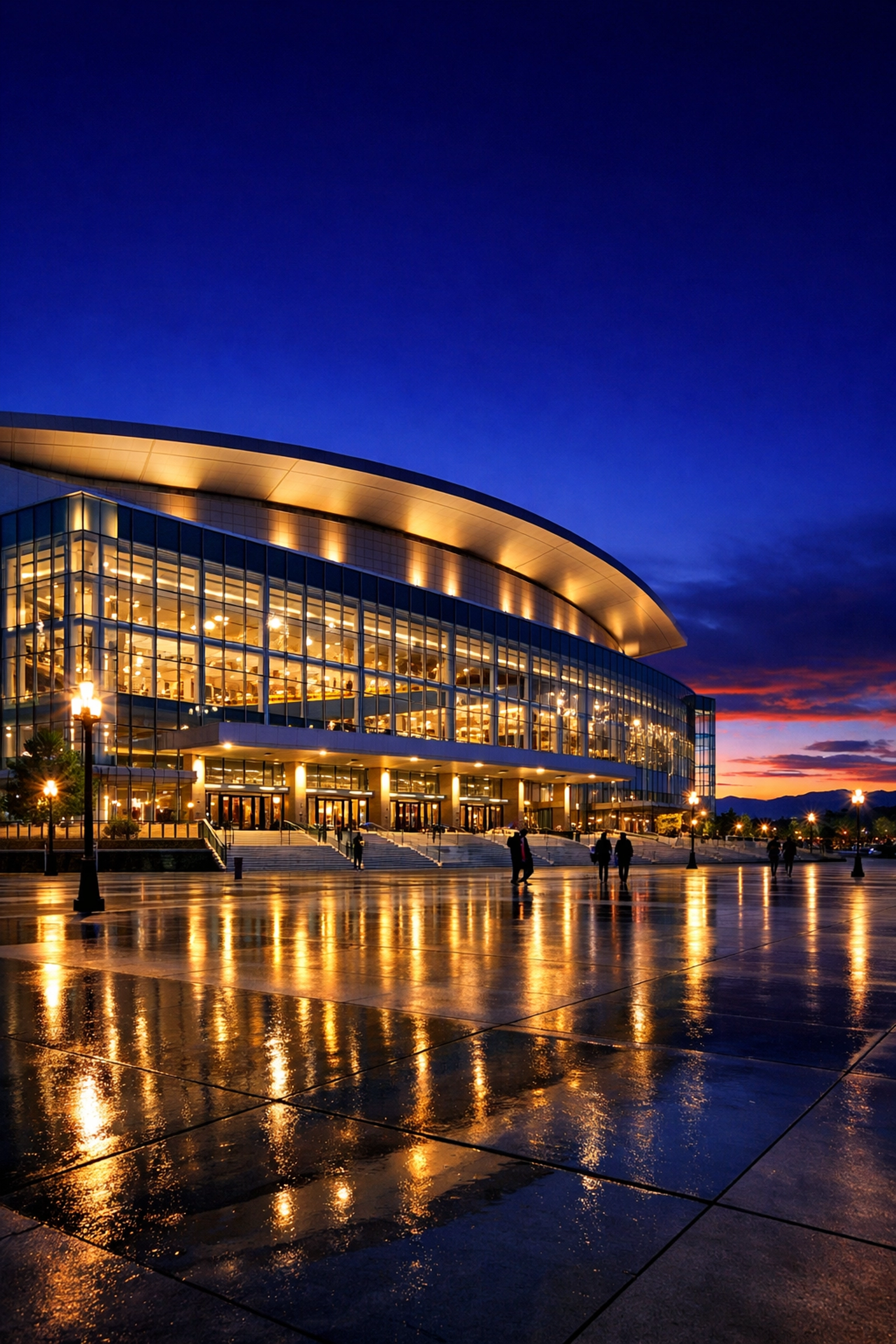 A modern sports and entertainment arena at twilight showcasing Dakdan Worldwide’s global media asset infrastructure.