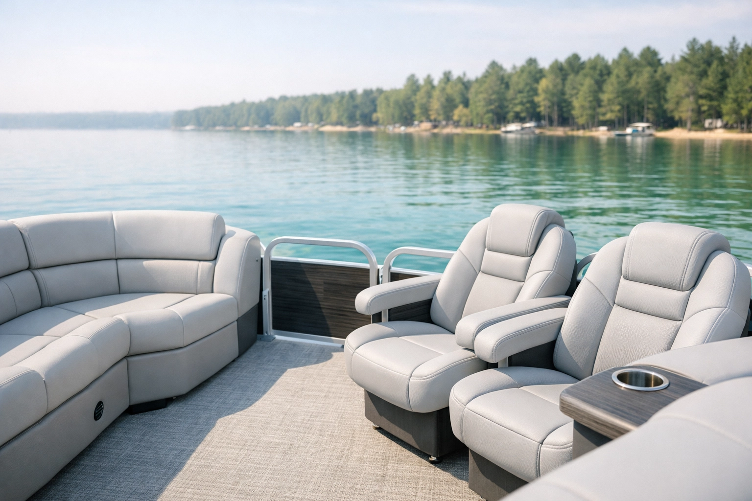 Premium light-grey pontoon boat seating on a Michigan lake, showcasing durable marine upholstery.