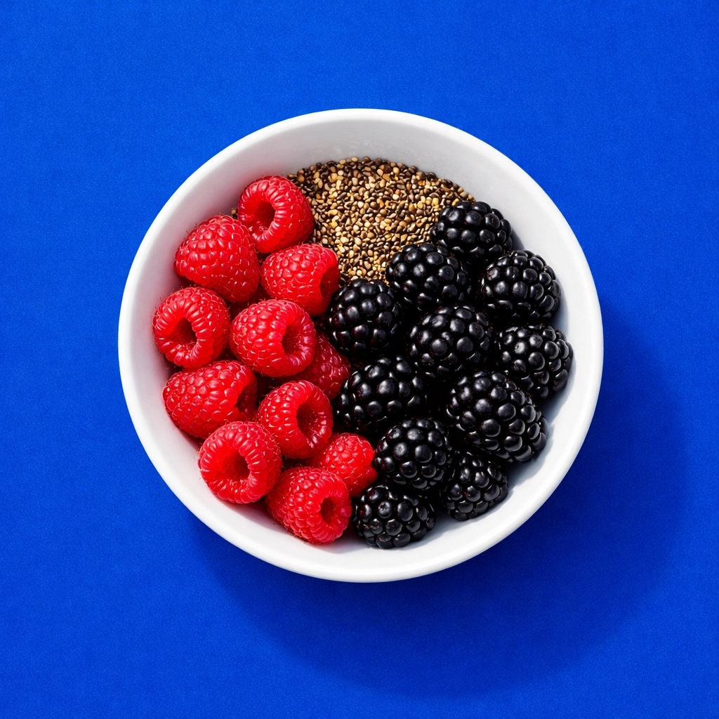 Fresh high-fiber berries and chia seeds in a bowl showing superfoods for gut health and performance.