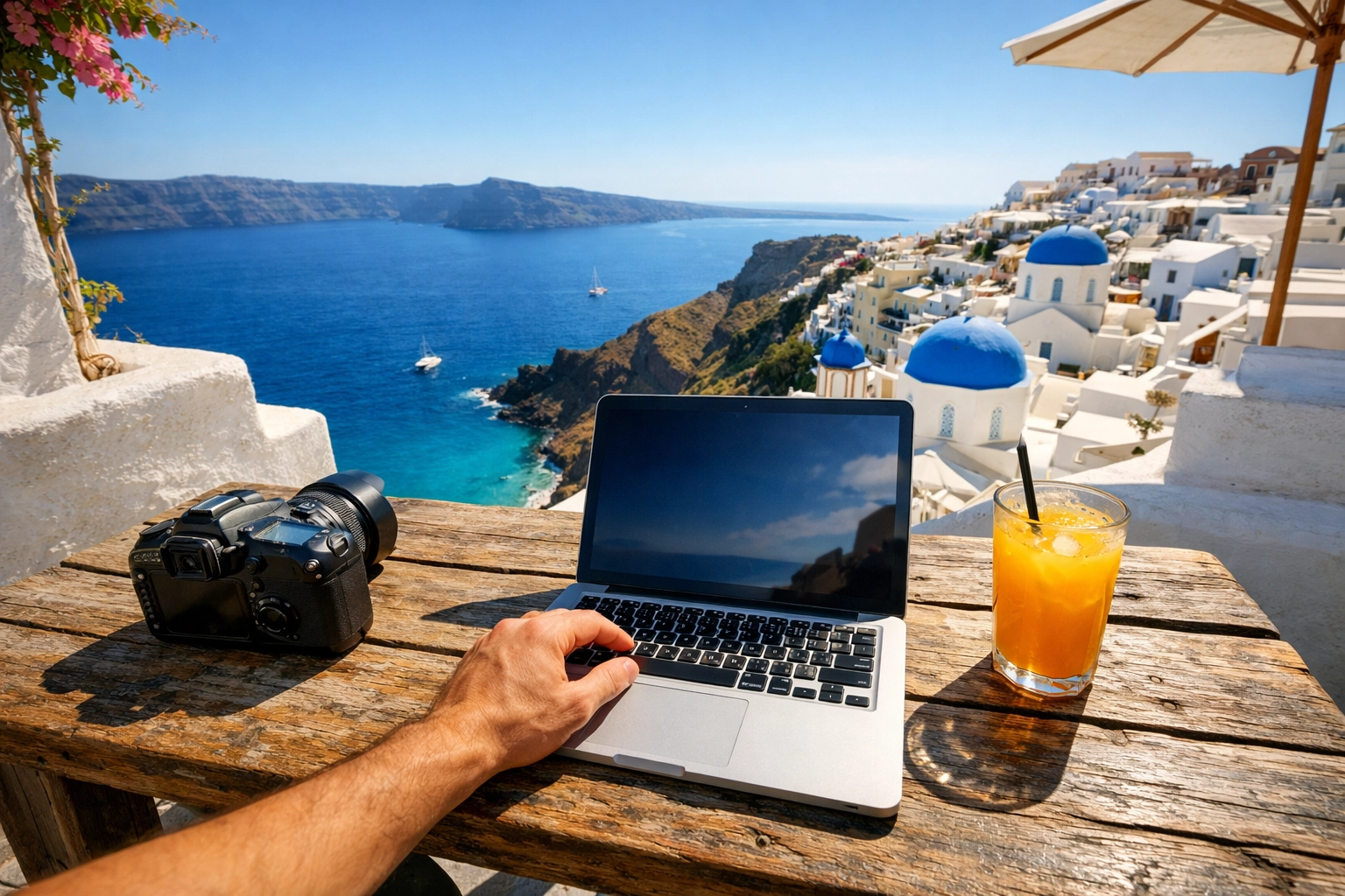 The Ultimate Guide to Finding Photography Work in 2026: Everything You Need to Succeed 3 Travel photography workspace on a balcony in Santorini for a digital nomad photographer.