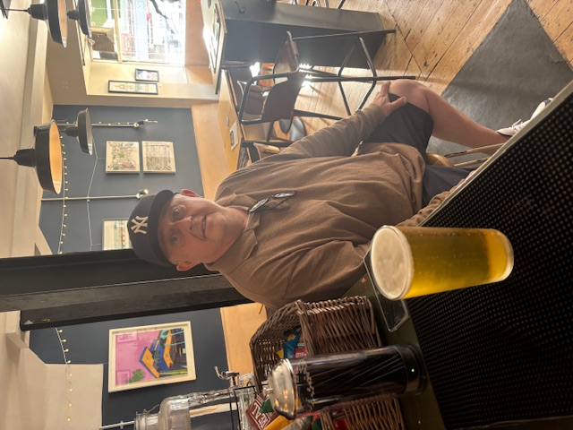 Lost and Found taproom interior A guest sits at the bar inside Lost and Found, enjoying the cozy atmosphere with a fresh pint of craft beer.