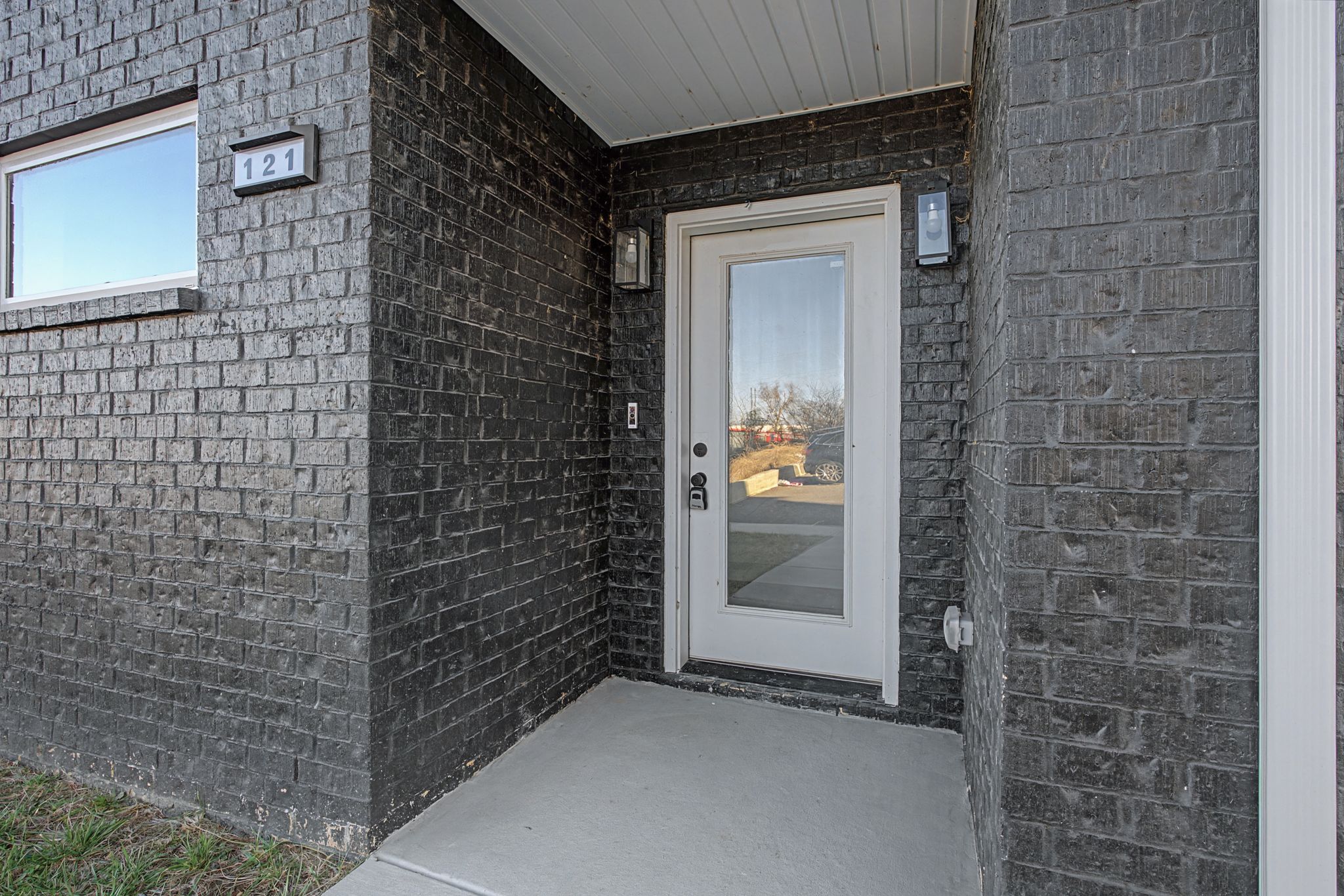 modern-covered-entryway-black-brick-glass-door.jpg
