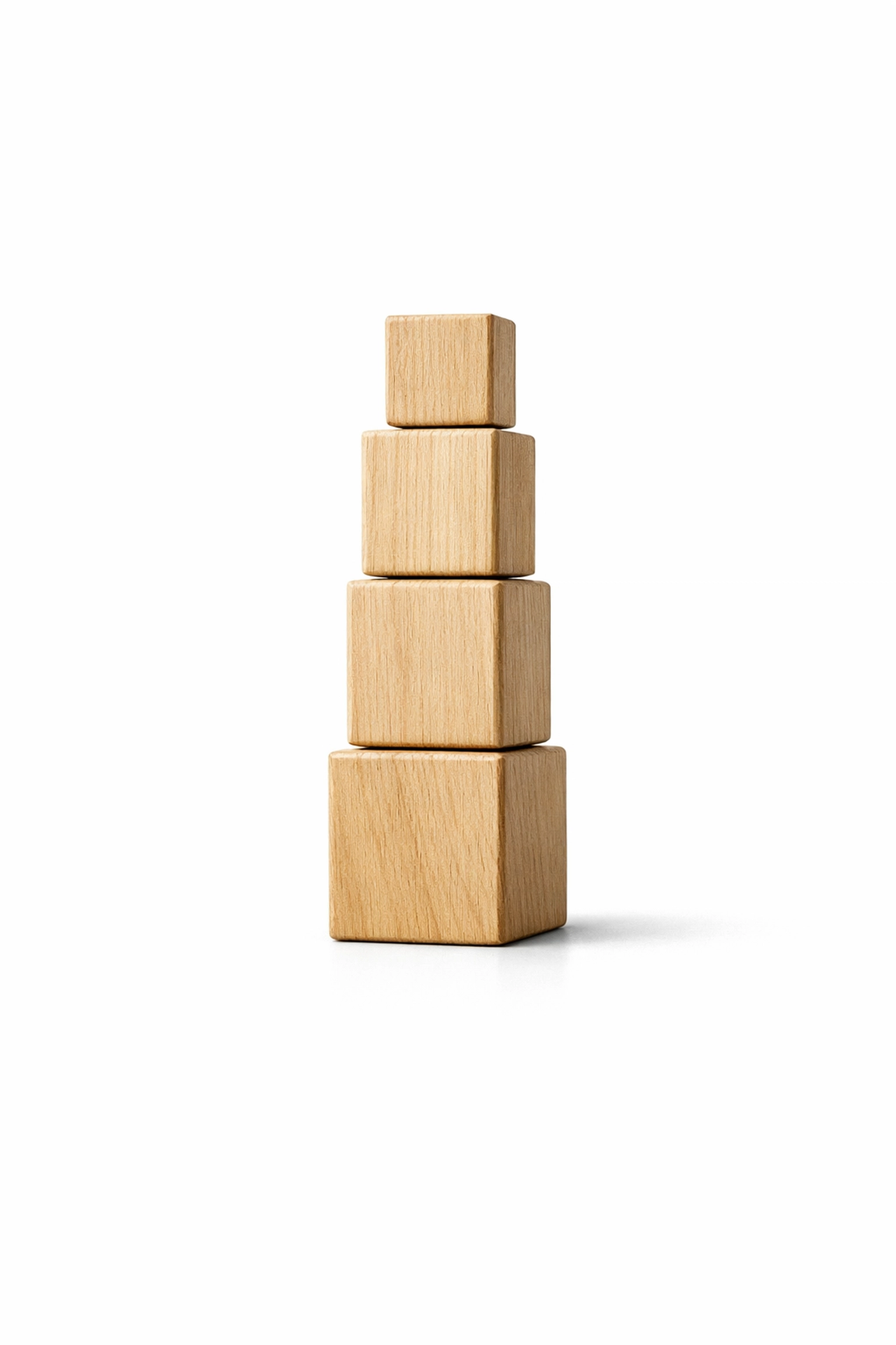 Stacked wooden blocks on a white background illustrating the building block method for structuring a shortened book or novella.